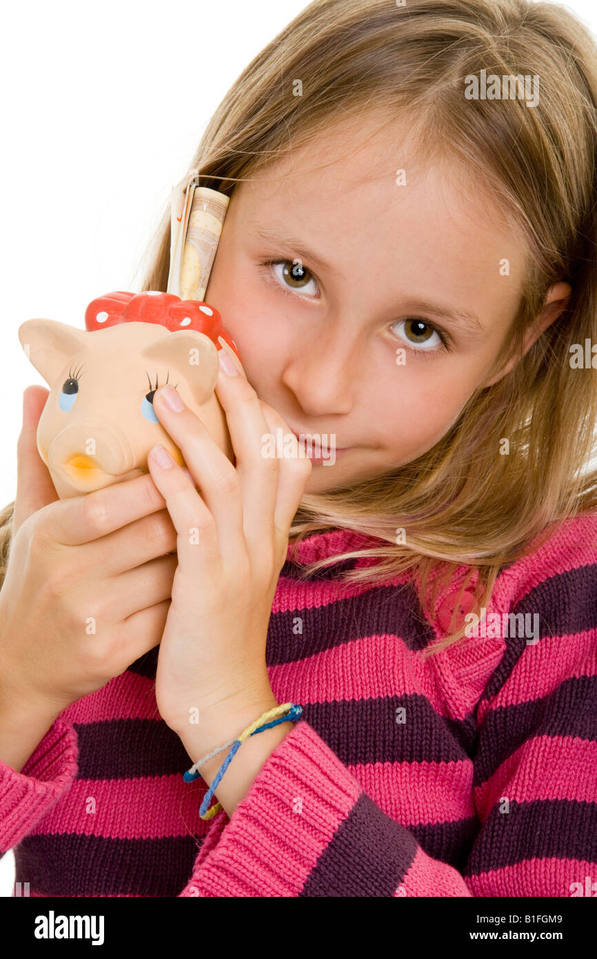 young blonde girl putting money in her piggy bank Stock Photo - Alamy