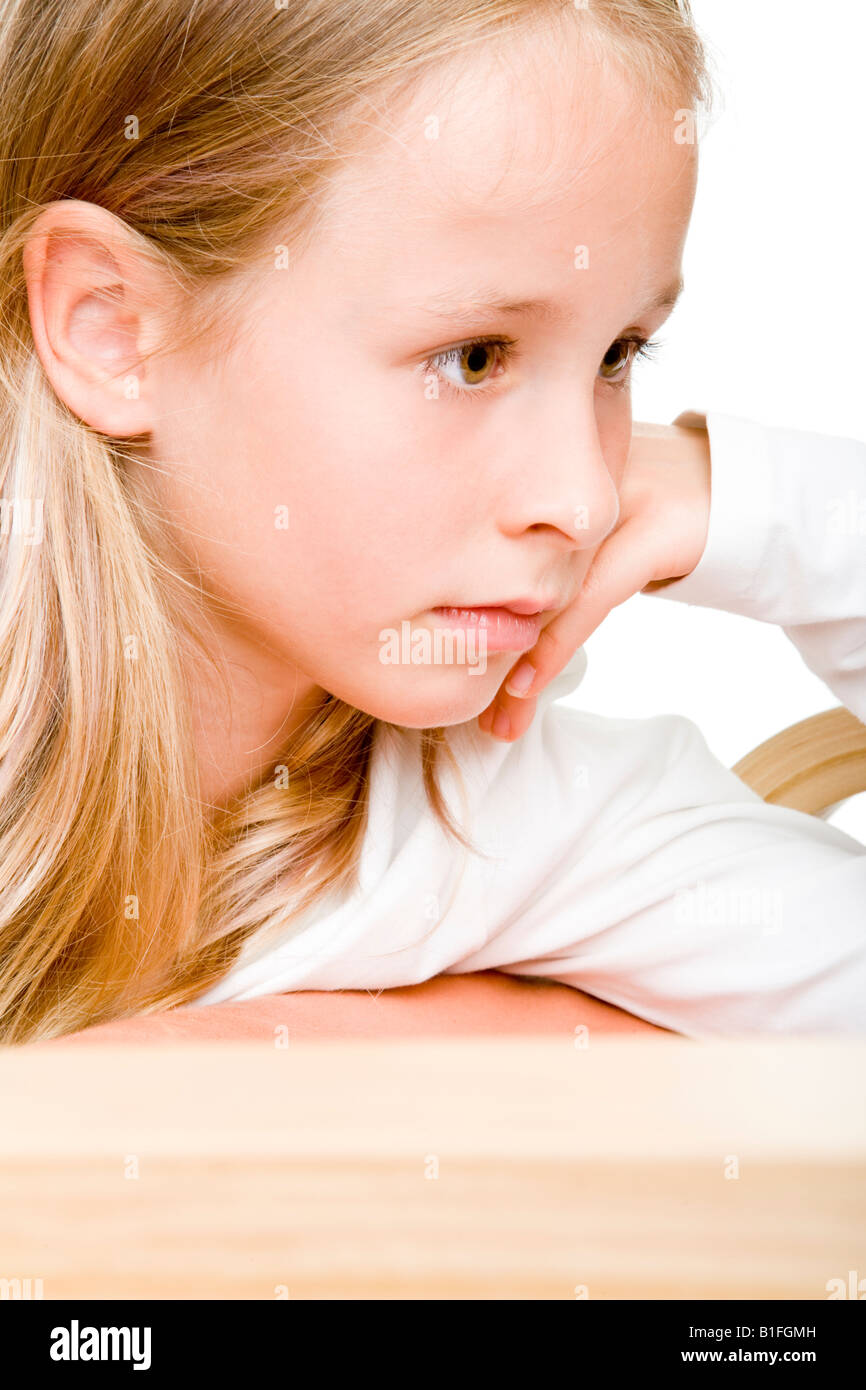 young blonde girl looks concentrative Stock Photo