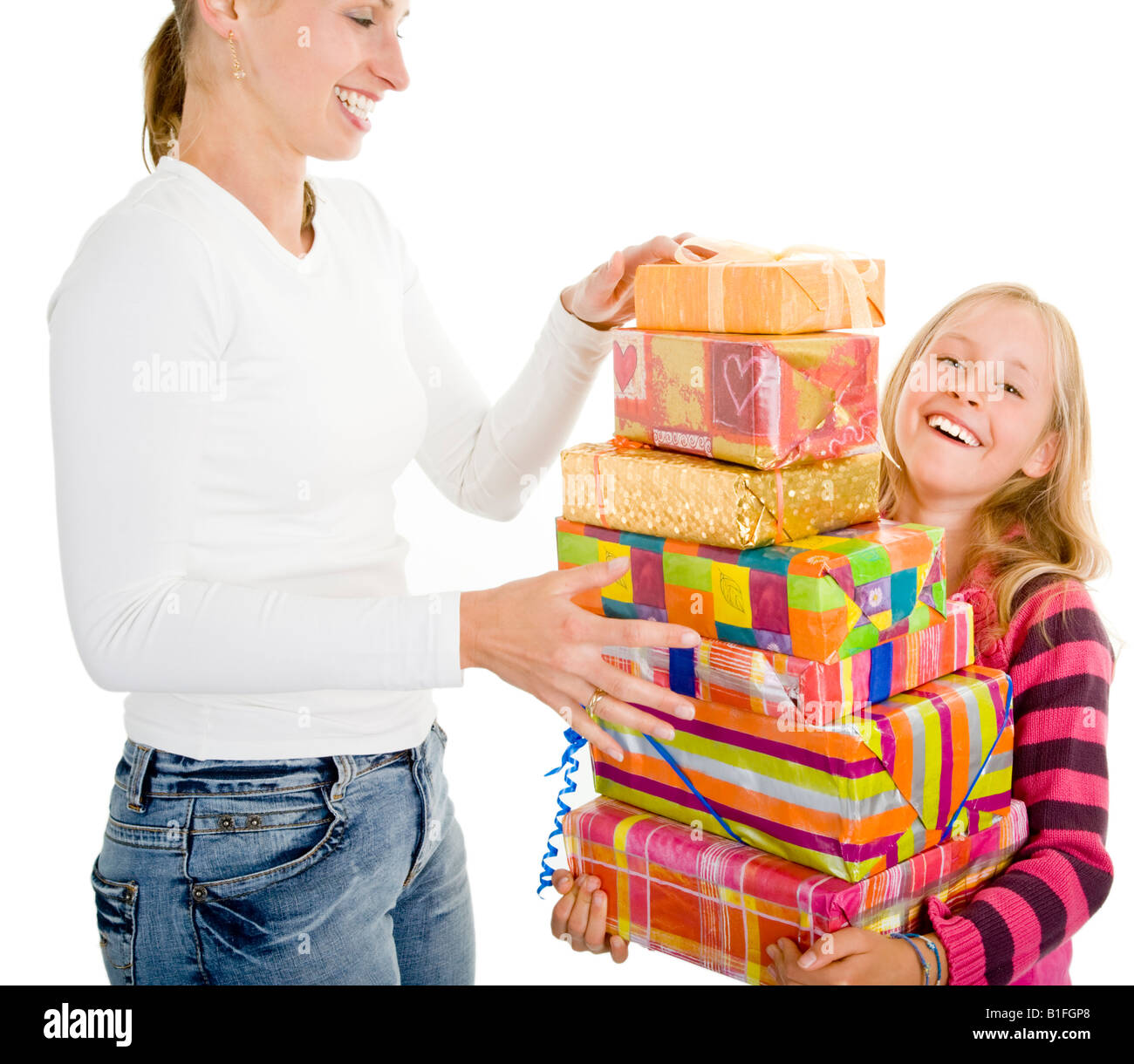 young girl and her mother are packing gifts Stock Photo