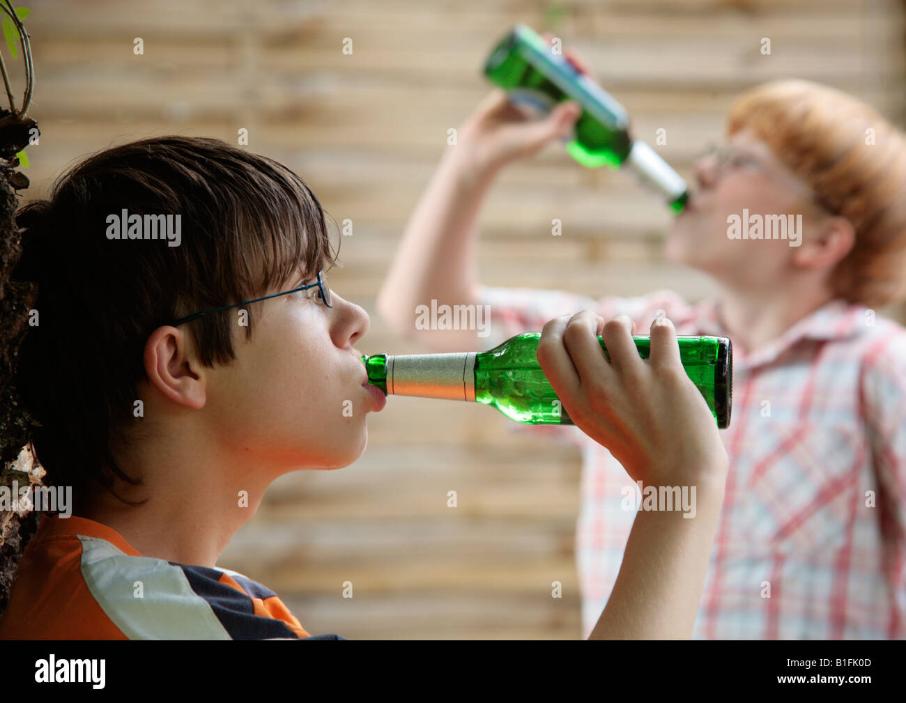 posed portrait of two young boys drinking beer Stock Photo