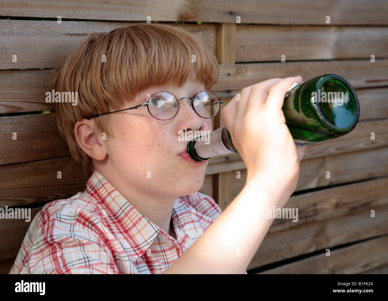 posed portrait of a young boy drinking beer Stock Photo Alamy