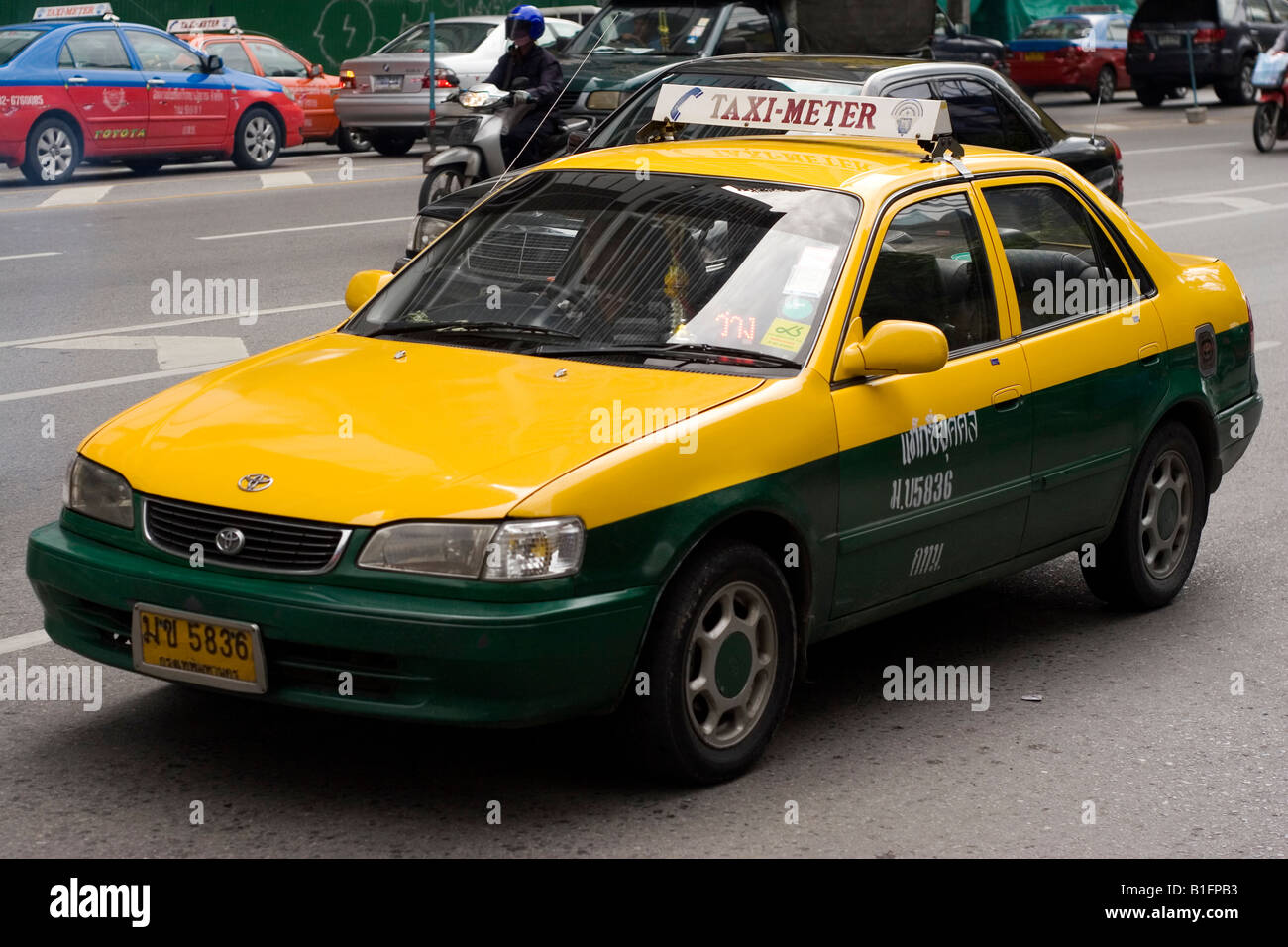 A yellow taxi in Bangkok, Thailand. Metered taxis are a cost effective