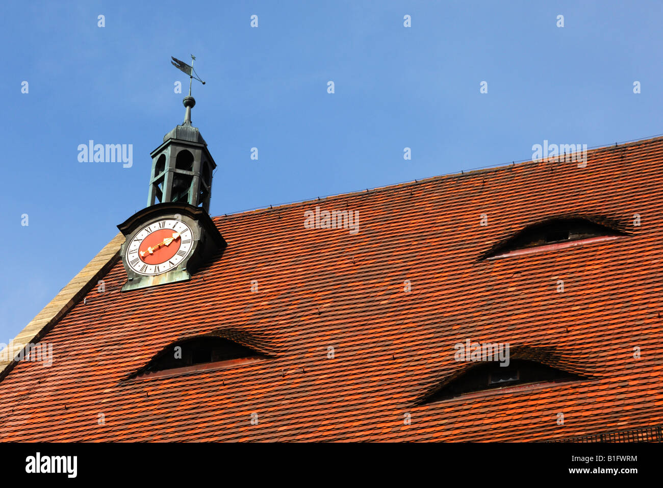 Tiled roof with dormer, clocktower, and weather vane, parish church St Johannis, Ansbach, Bavaria, Germany Stock Photo