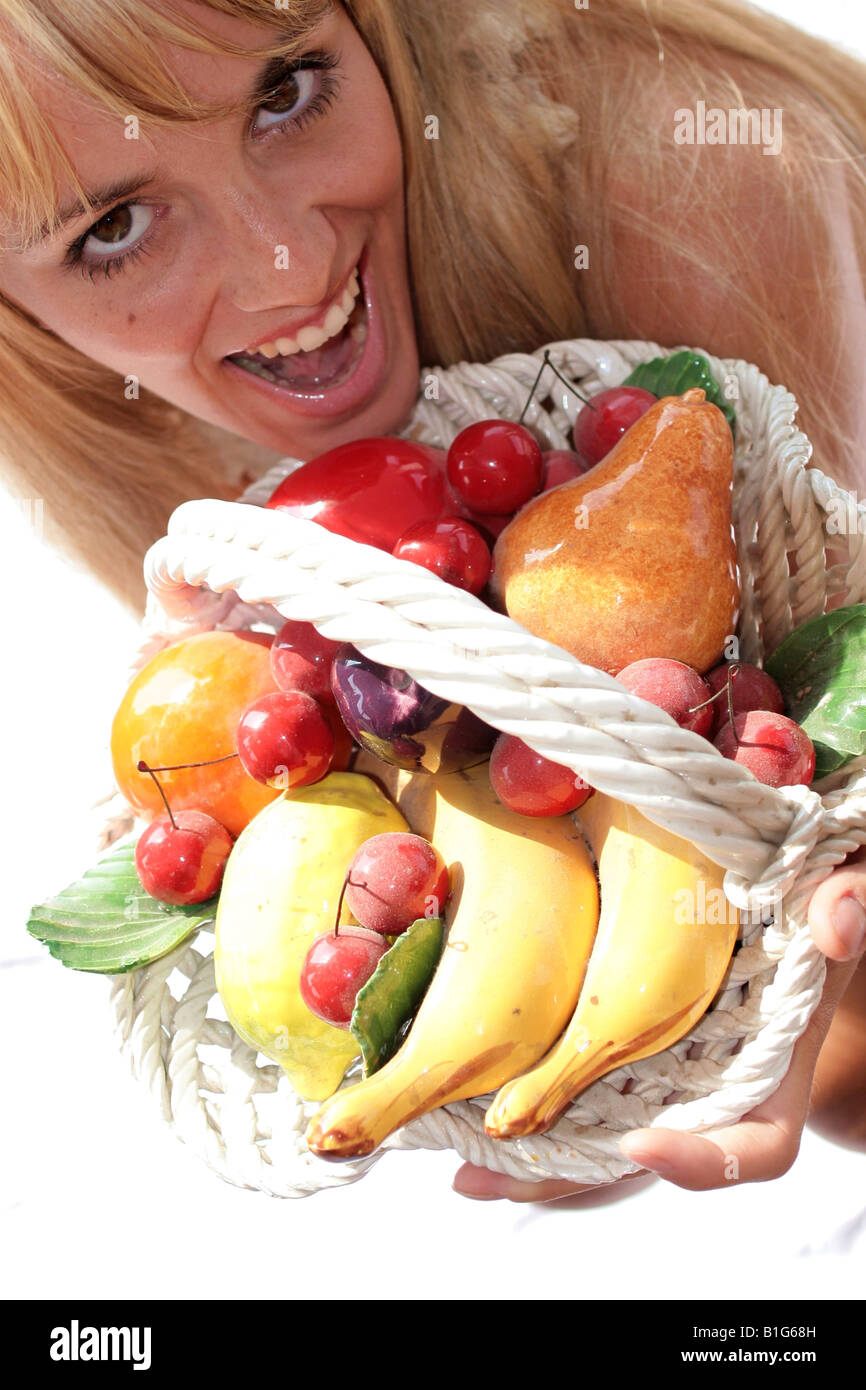 Overhead view of a woman smiling and holding fruit basket Stock Photo ...