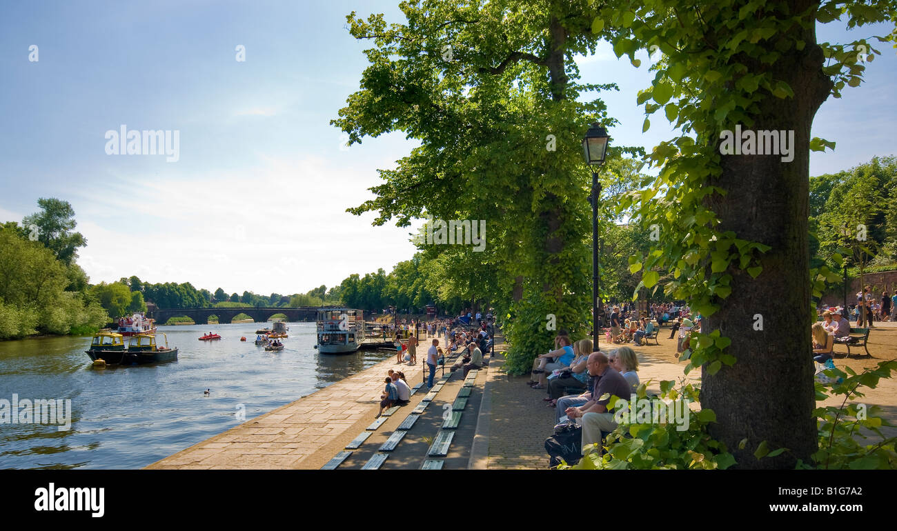 Visitors and holiday makers enjoy the sun on the banks of River Dee Chester Stock Photo
