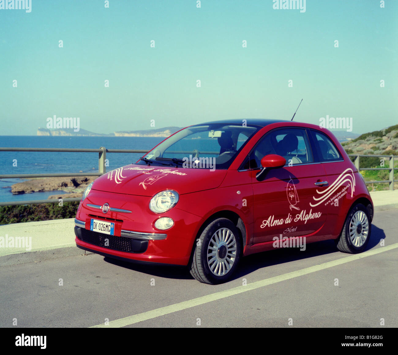 Italy Sardinia new red rental Fiat 500 from Hotel Alma Alghero with sea