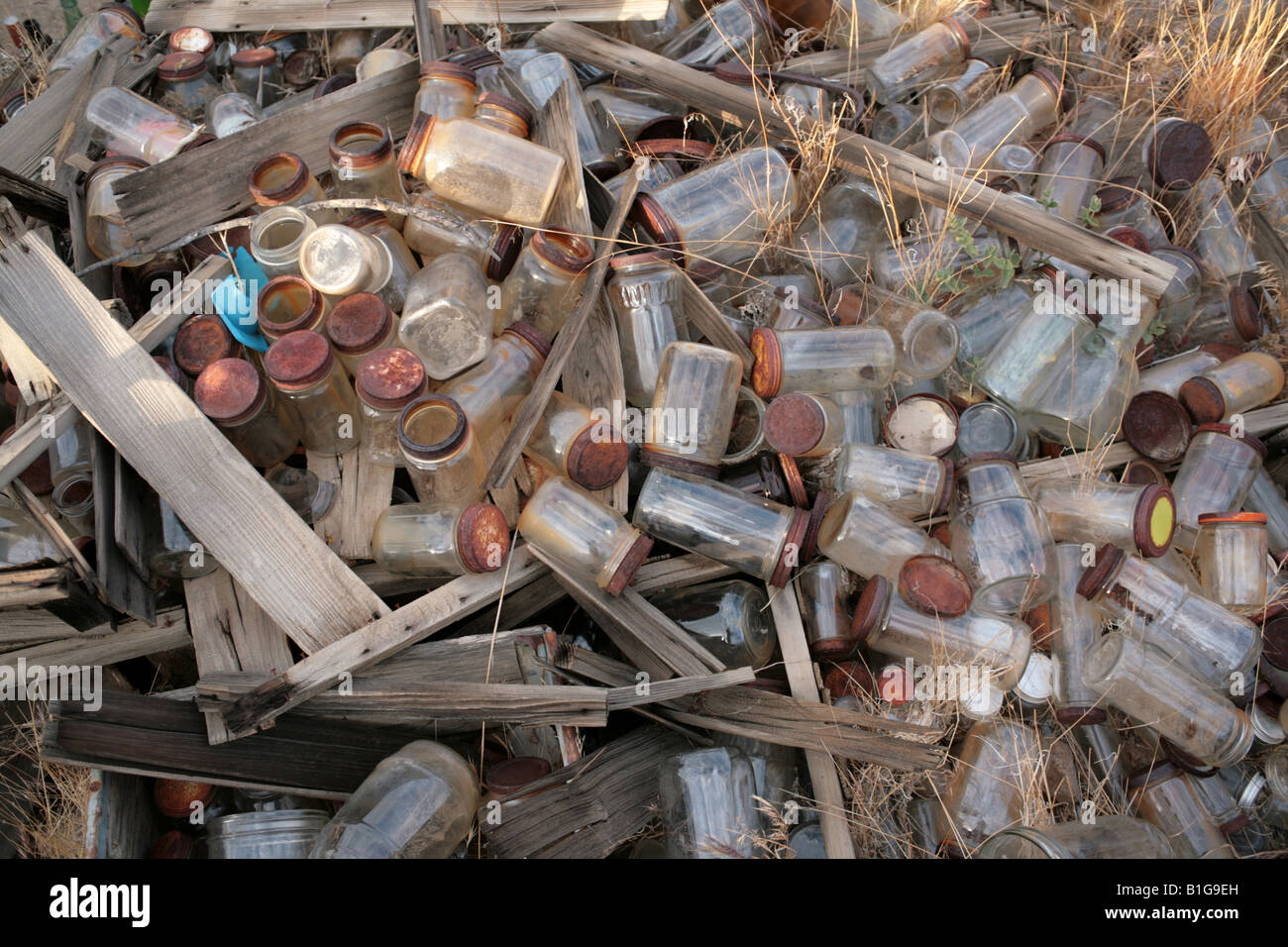 Jar With Rotted Old pile of rusty screw top food jars in a dump Stock Photo - Alamy