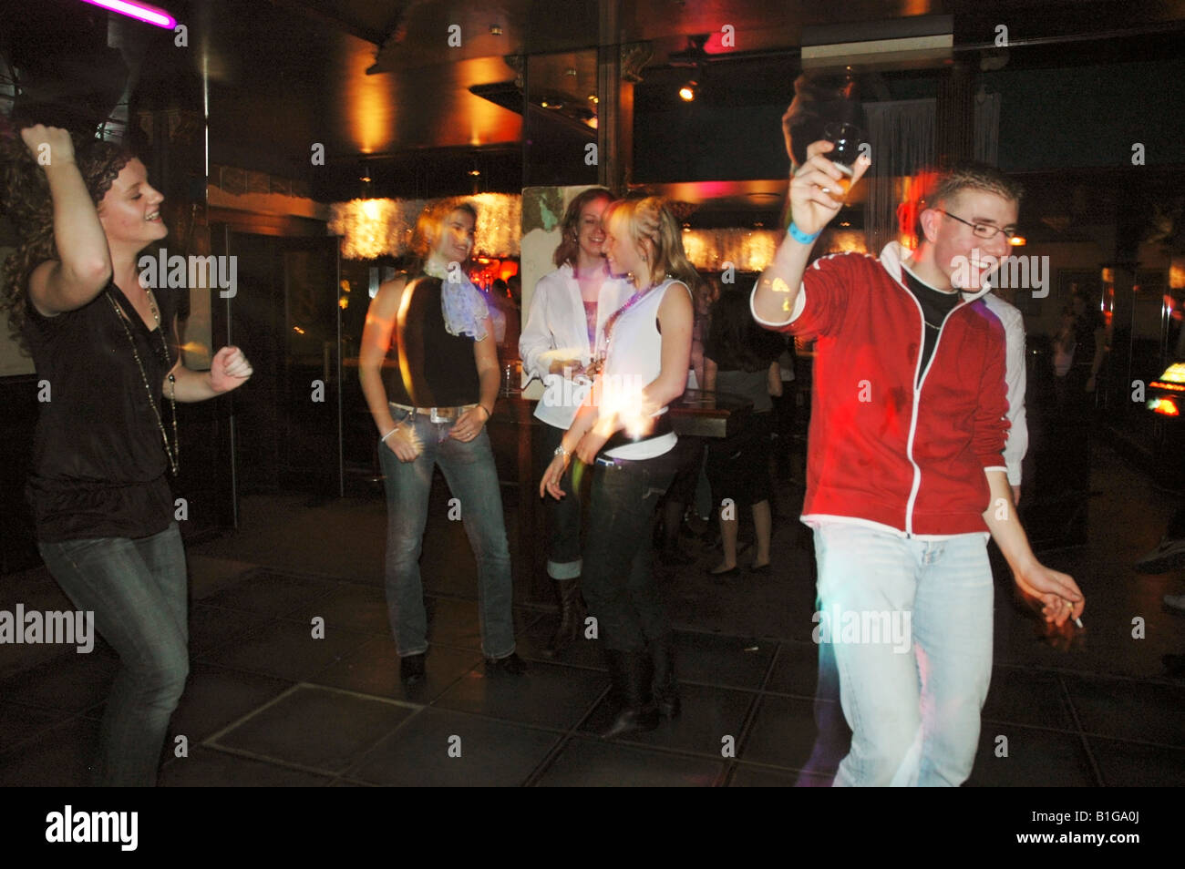 group of teenage boys and girls dancing at night club Stock Photo