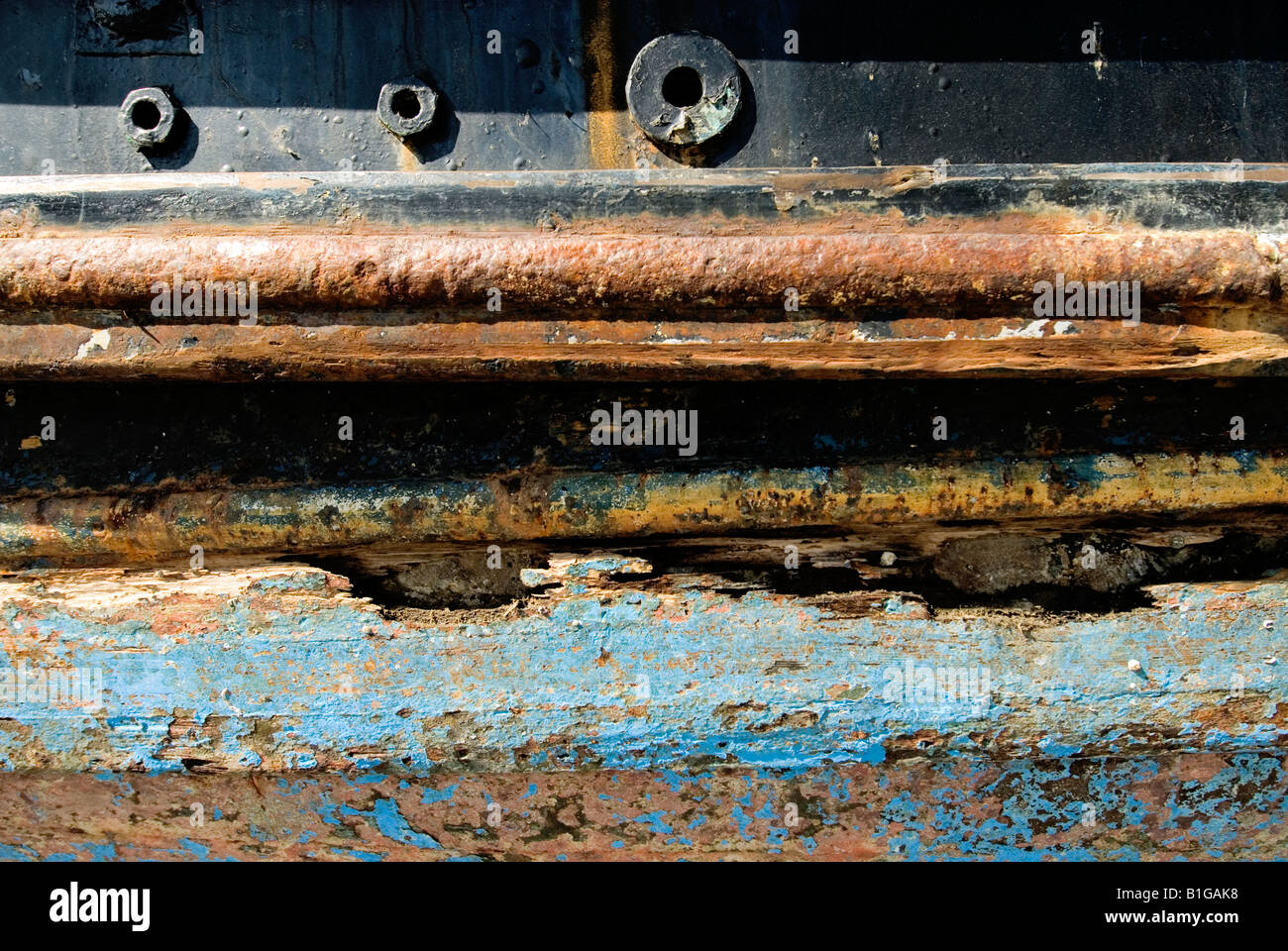 close up of antifouling paint peeling on a rusty boats hull rotting wood Stock Photo