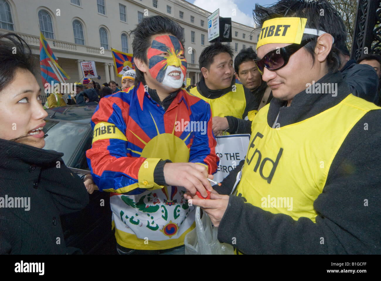 Protesters with Tibetan flags & face paint in London Support Tibet march calling for an end to human rights abuses by China Stock Photo