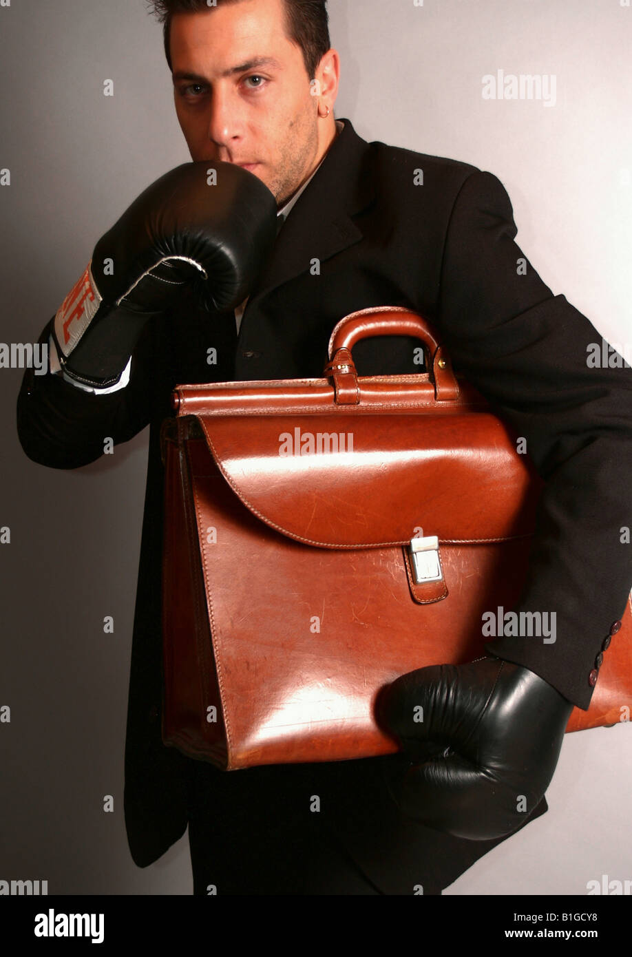 Studio shot of a businessman holding bag Stock Photo - Alamy
