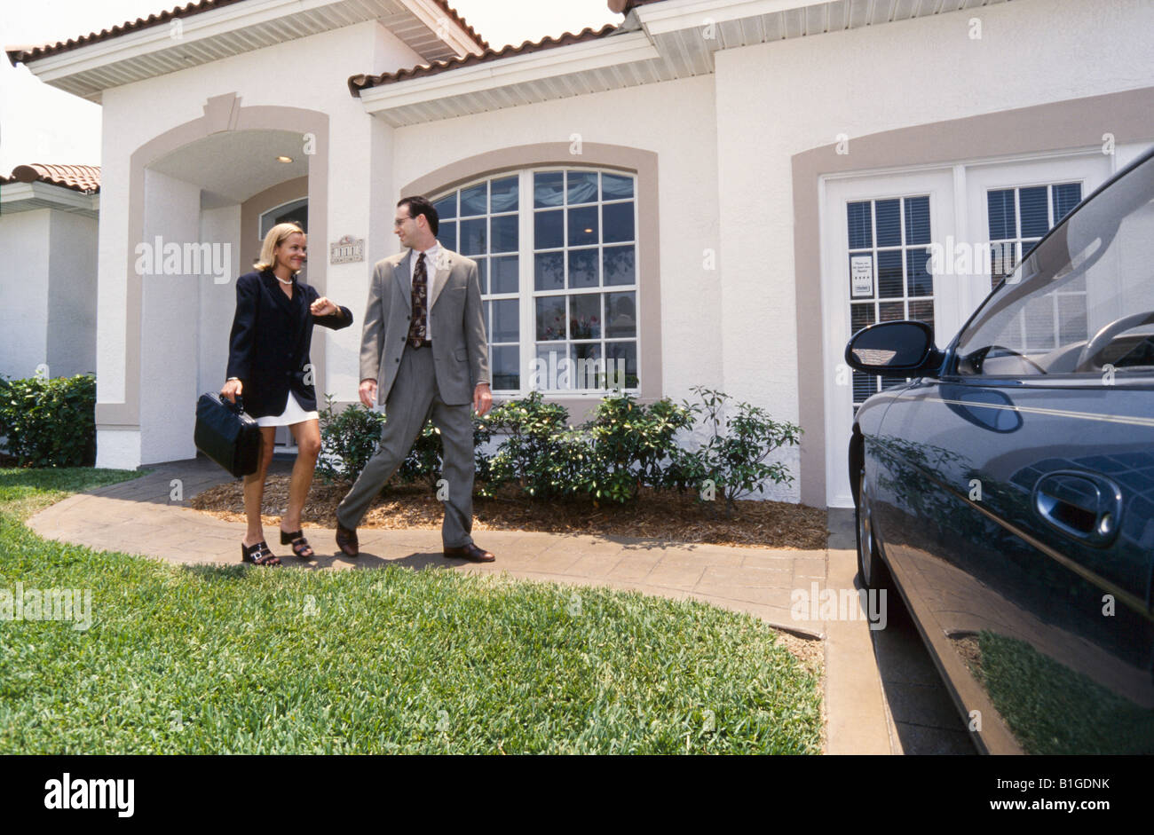 Couple leaving home for work, together Stock Photo Alamy
