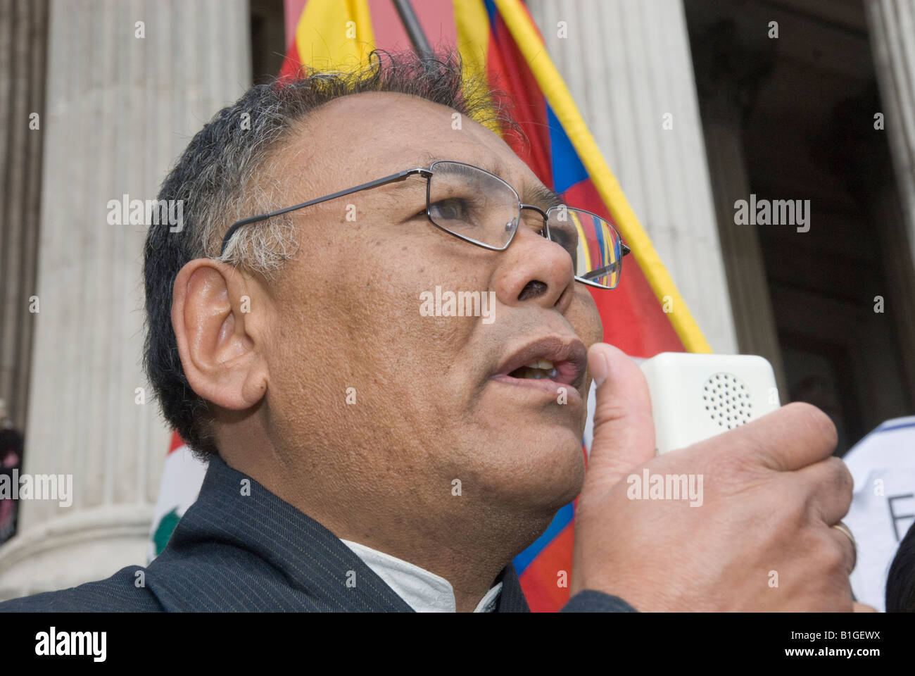 A Tibetan speaker at rally at end of Support Tibet march through London calling for an end to human rights abuses by China. Stock Photo
