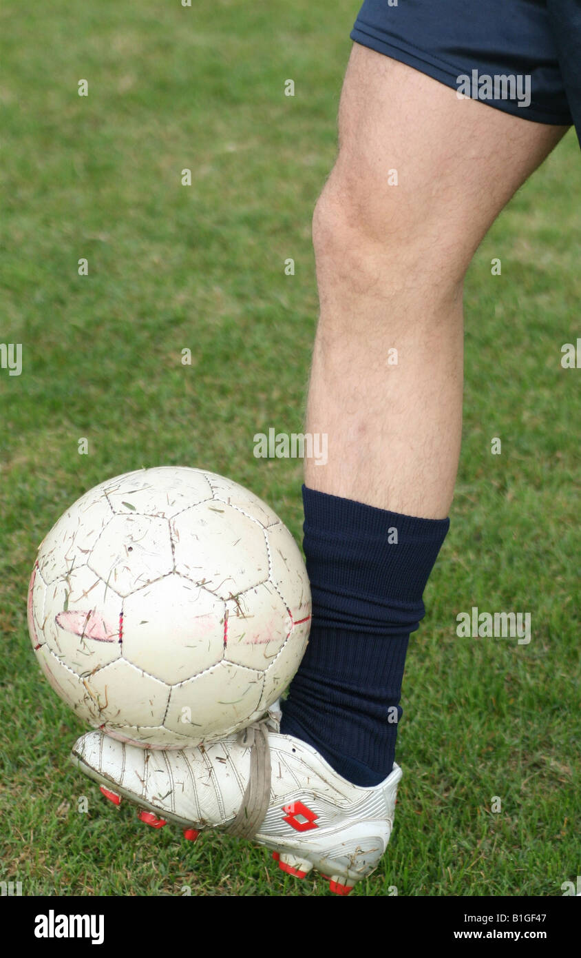 Detail of a footballer leg playing with ball Stock Photo
