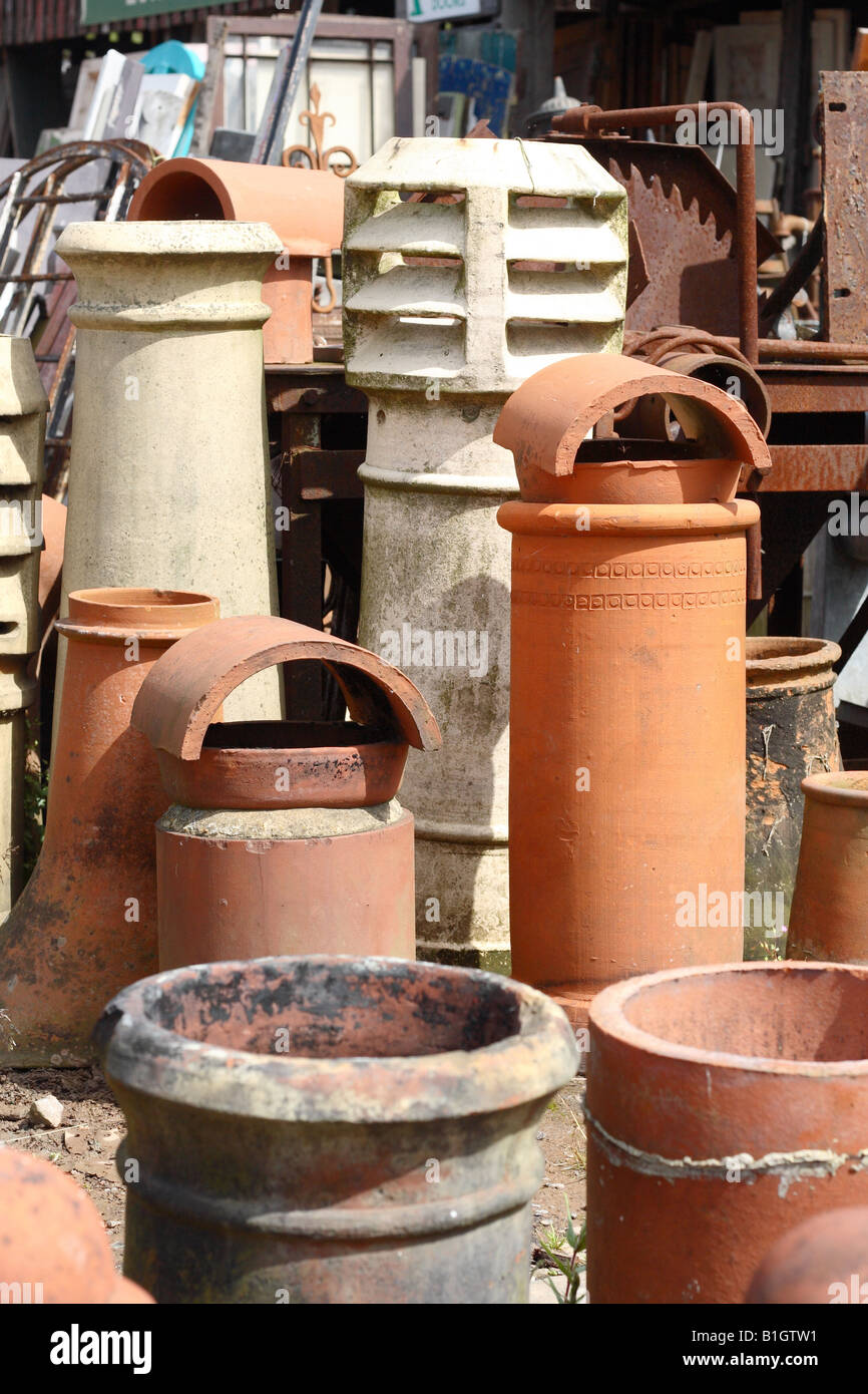 Old second hand chimney pot stack for sale in a building material reclamation yard Stock Photo