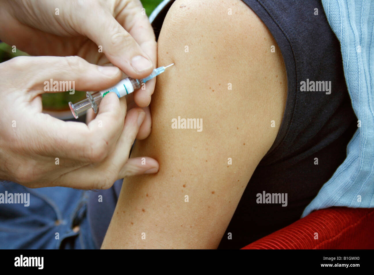 giving an intramuscular injection in arm Stock Photo