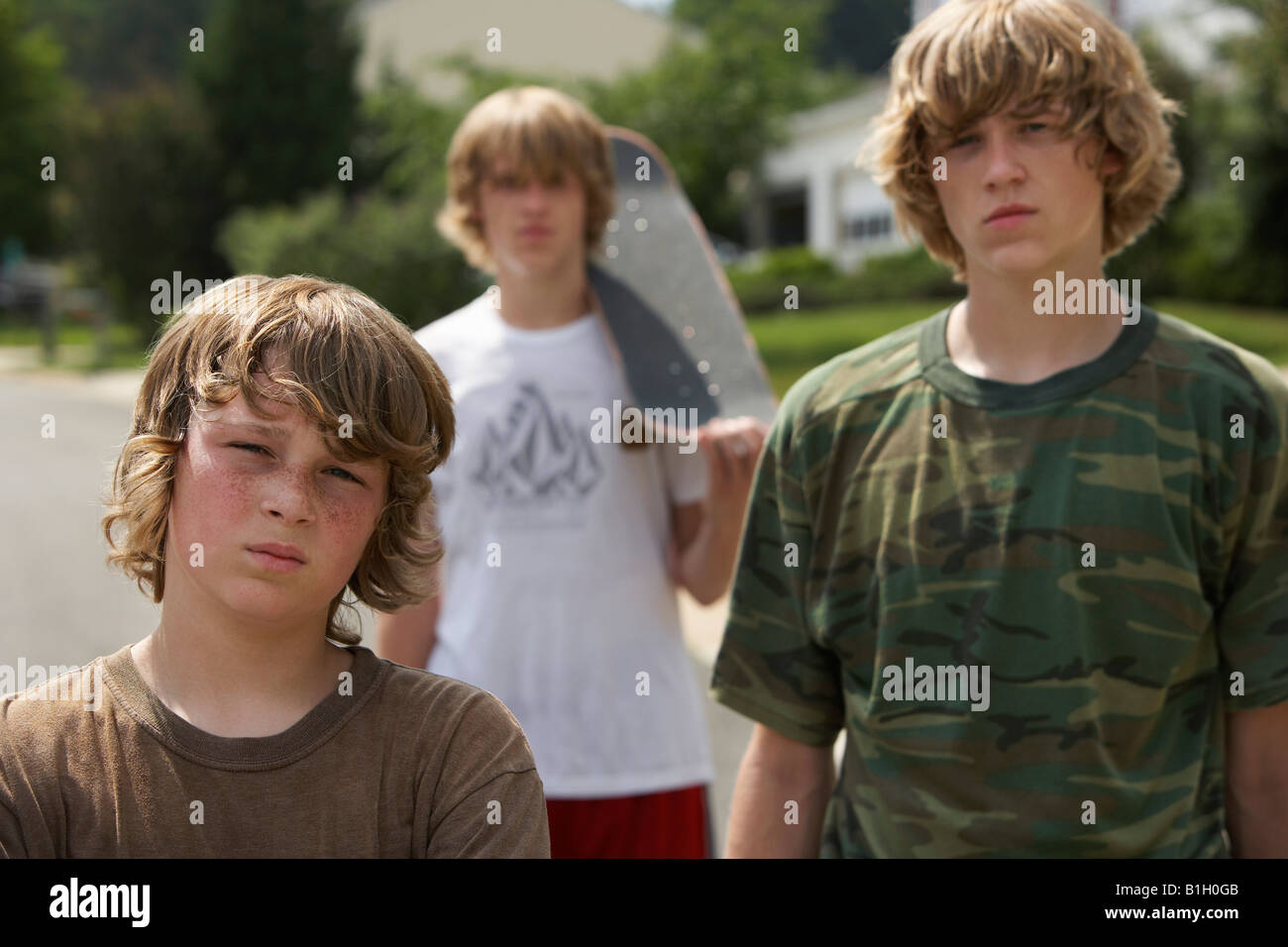 Three teenage brothers (1317) standing on street, portrait Stock Photo
