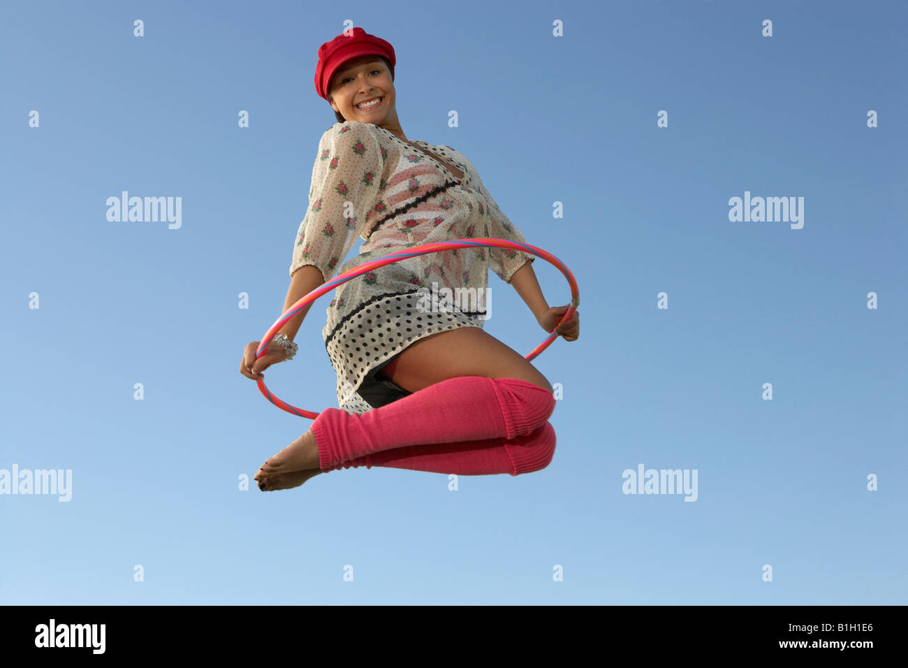 Jumping In Hoops Portrait of woman jumping with Hula Hoop Stock Photo - Alamy