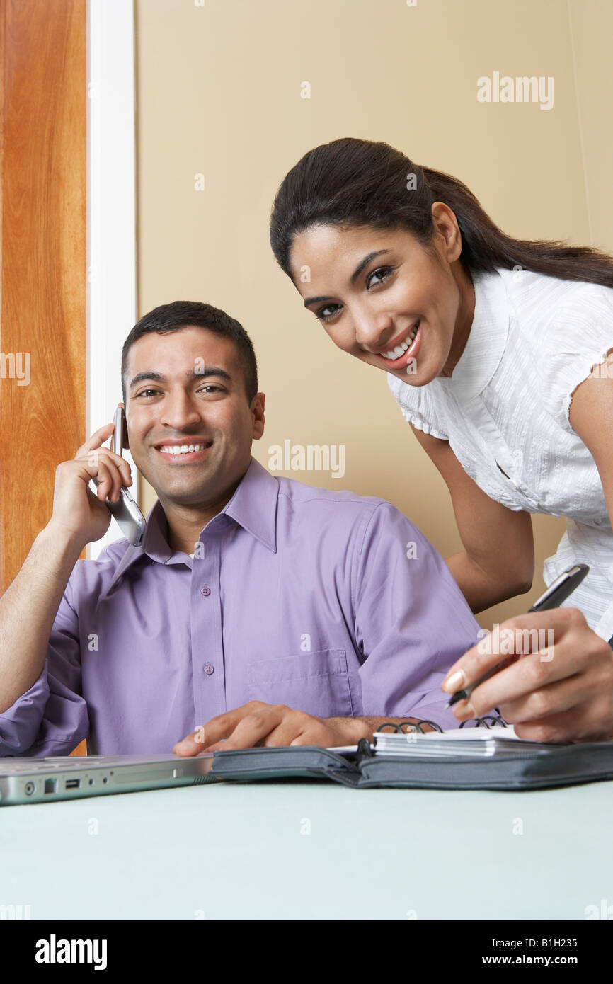 Business man and woman working at desk in office, portrait Stock Photo ...