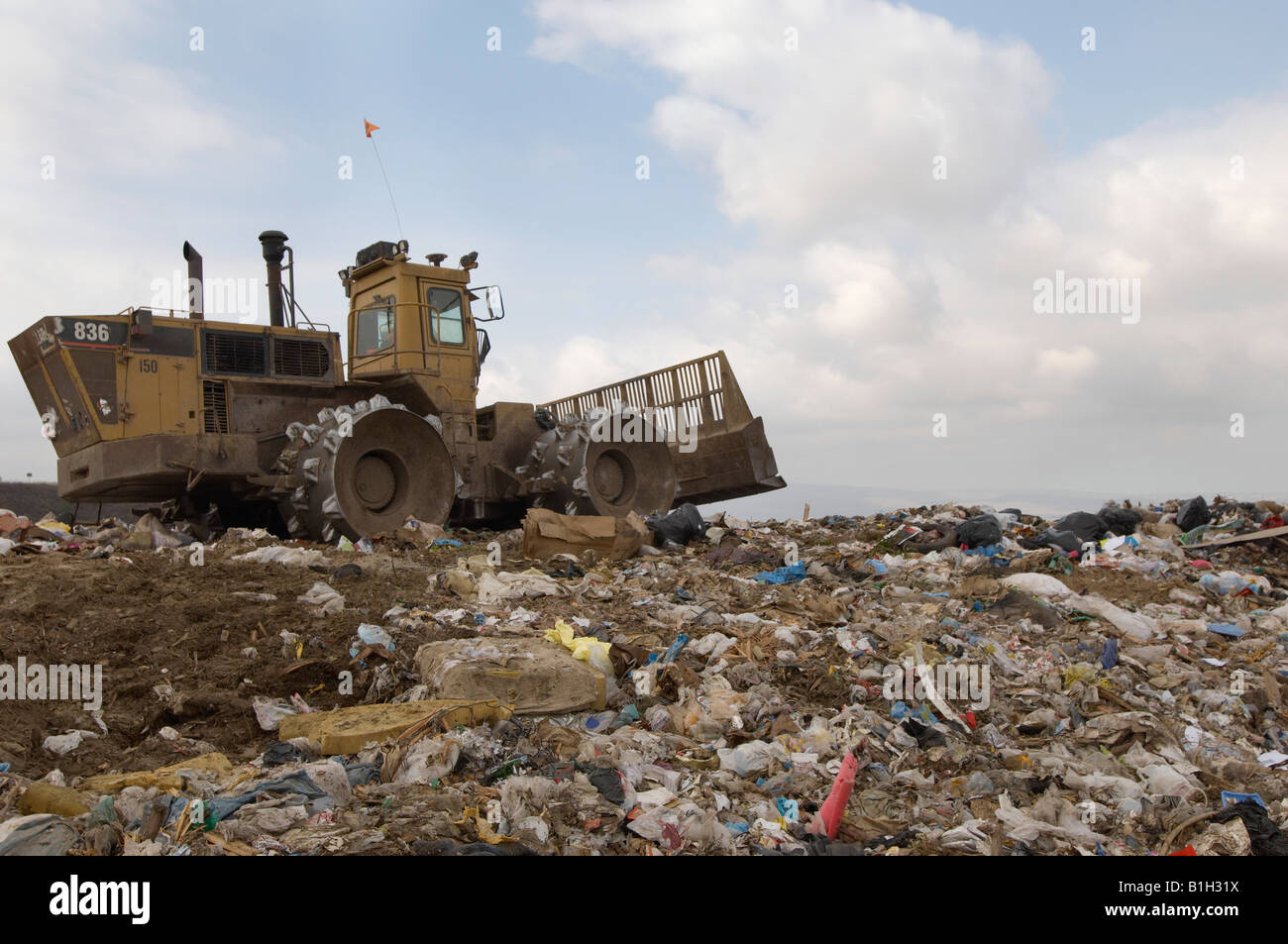 Digger working at landfill site Stock Photo - Alamy