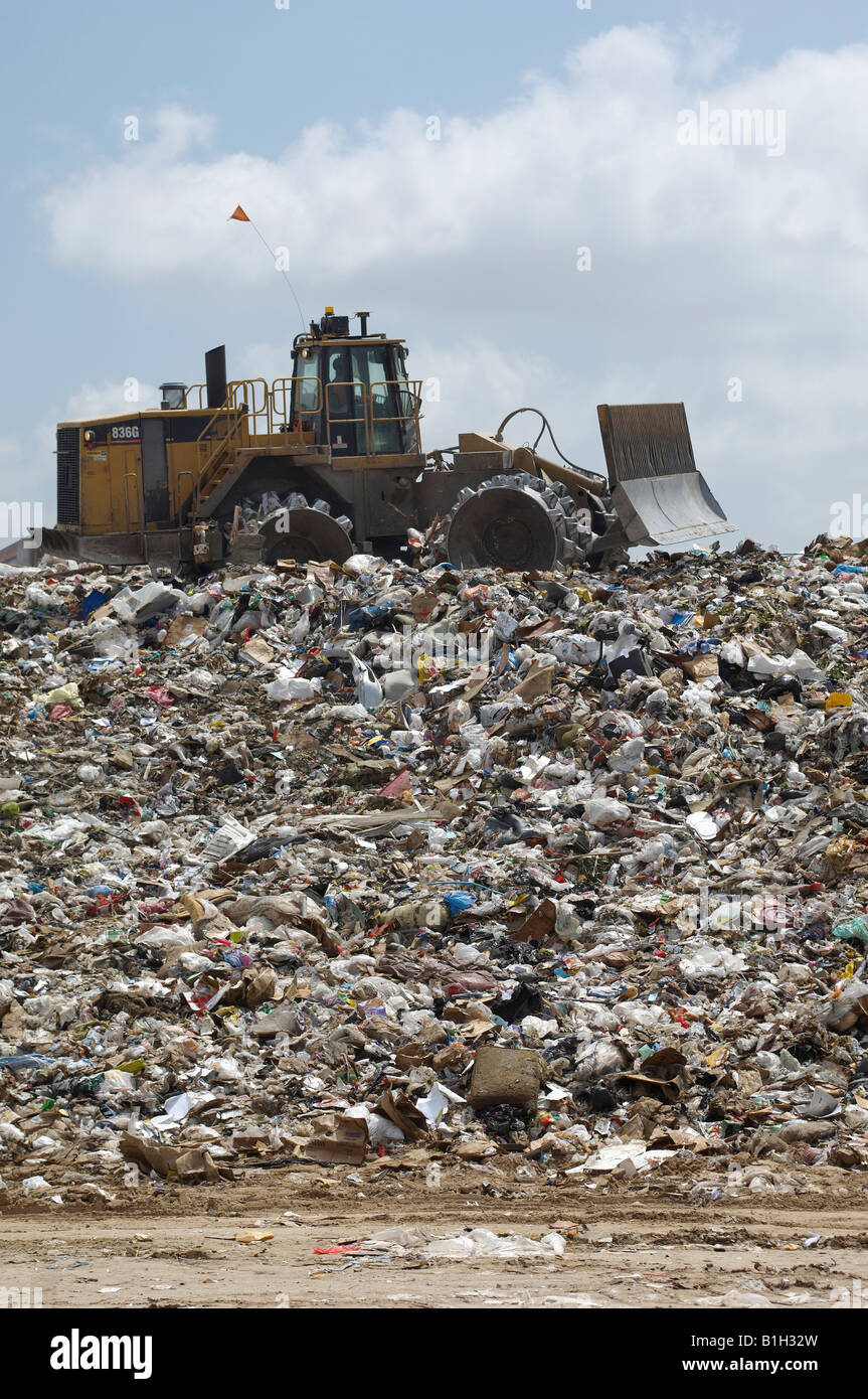 Digger working at landfill site Stock Photo - Alamy