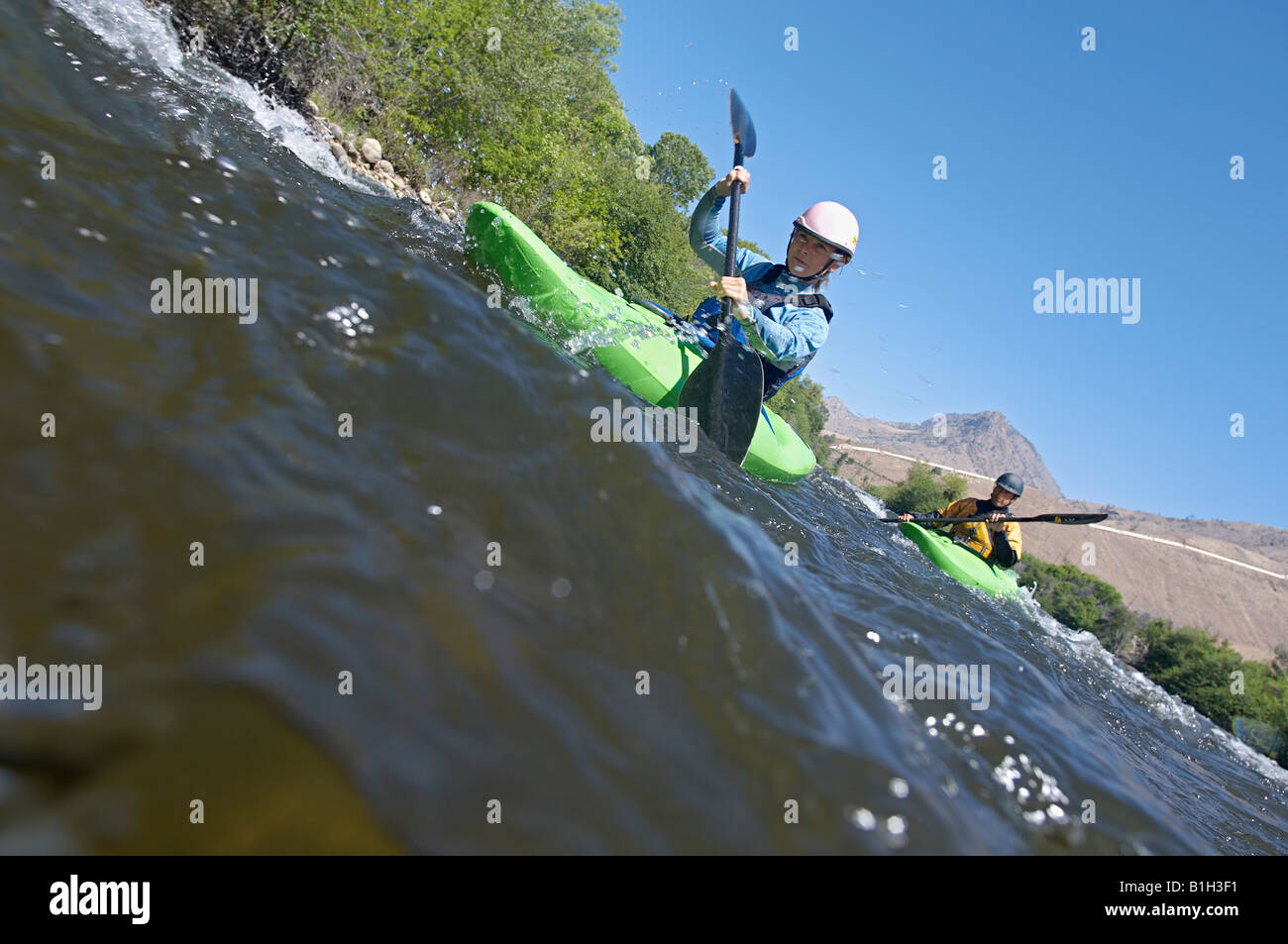 Two people kayaking in mountain river Stock Photo