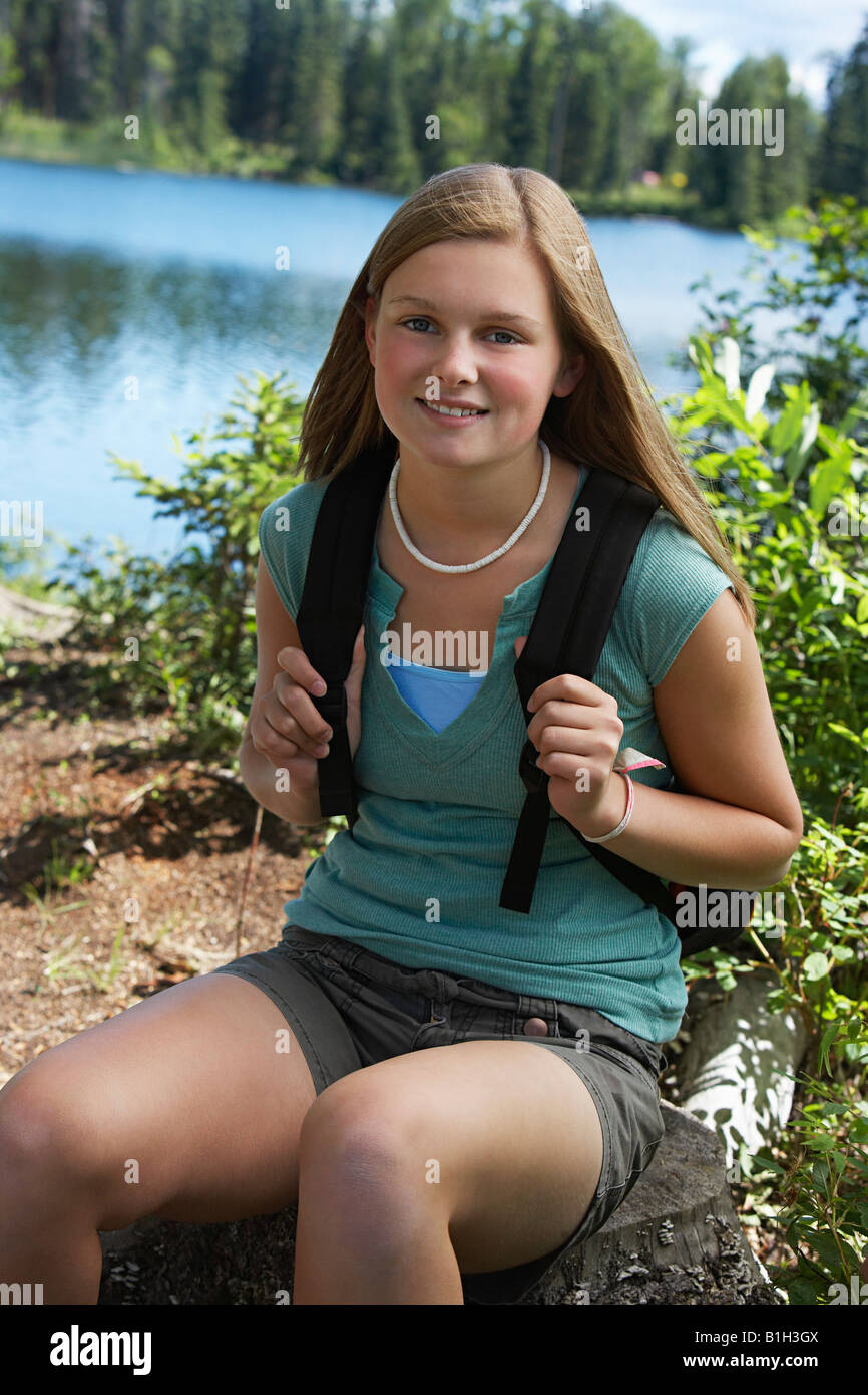 USA, Alaska, teenage girl wearing backpack at lake, portrait Stock