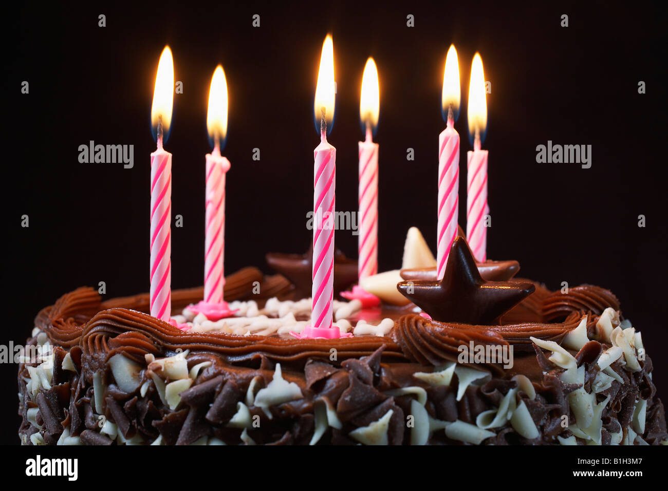Birthday cake with lit candles, close-up Stock Photo - Alamy