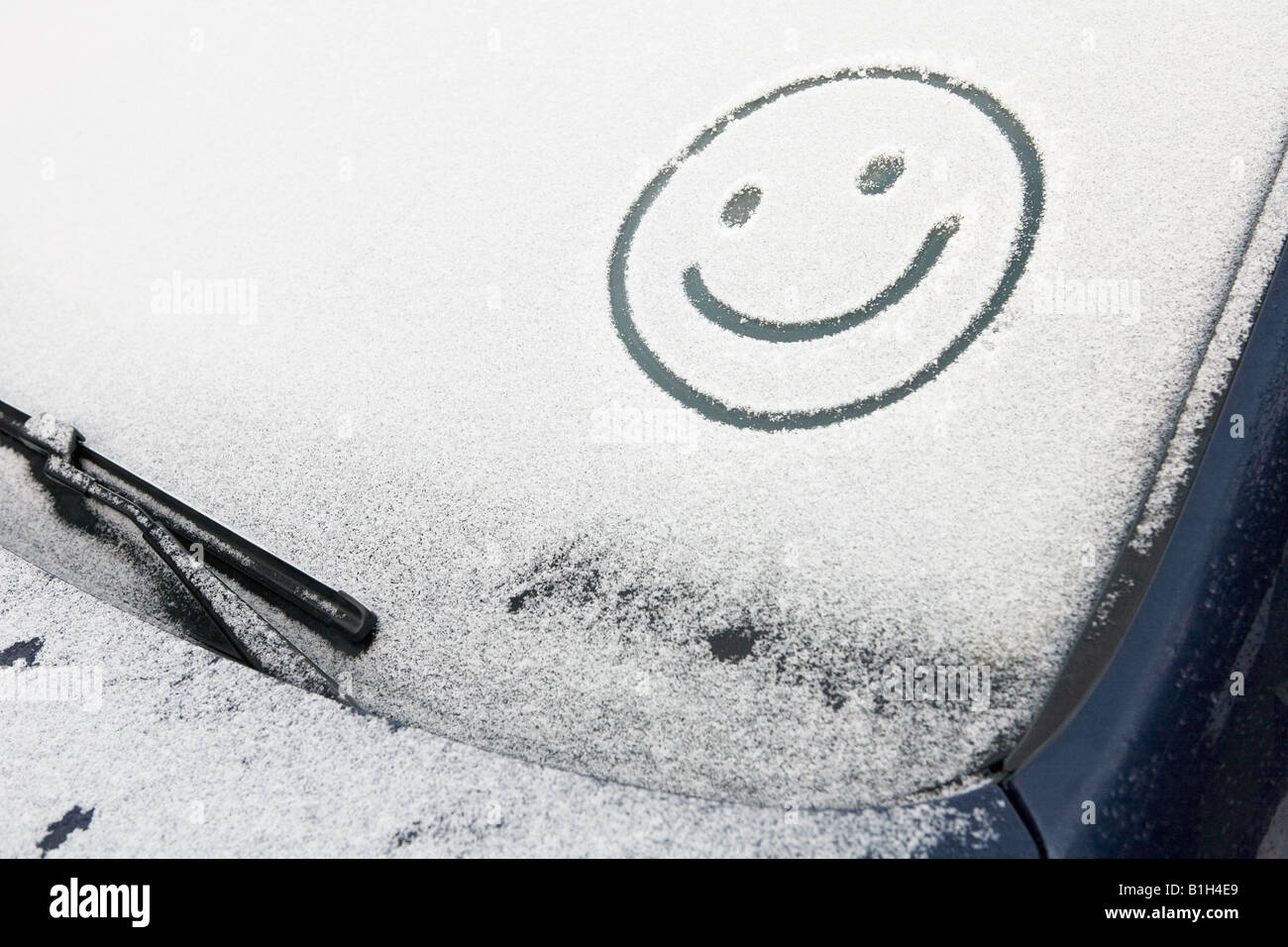 Smiley face in snow on car Stock Photo