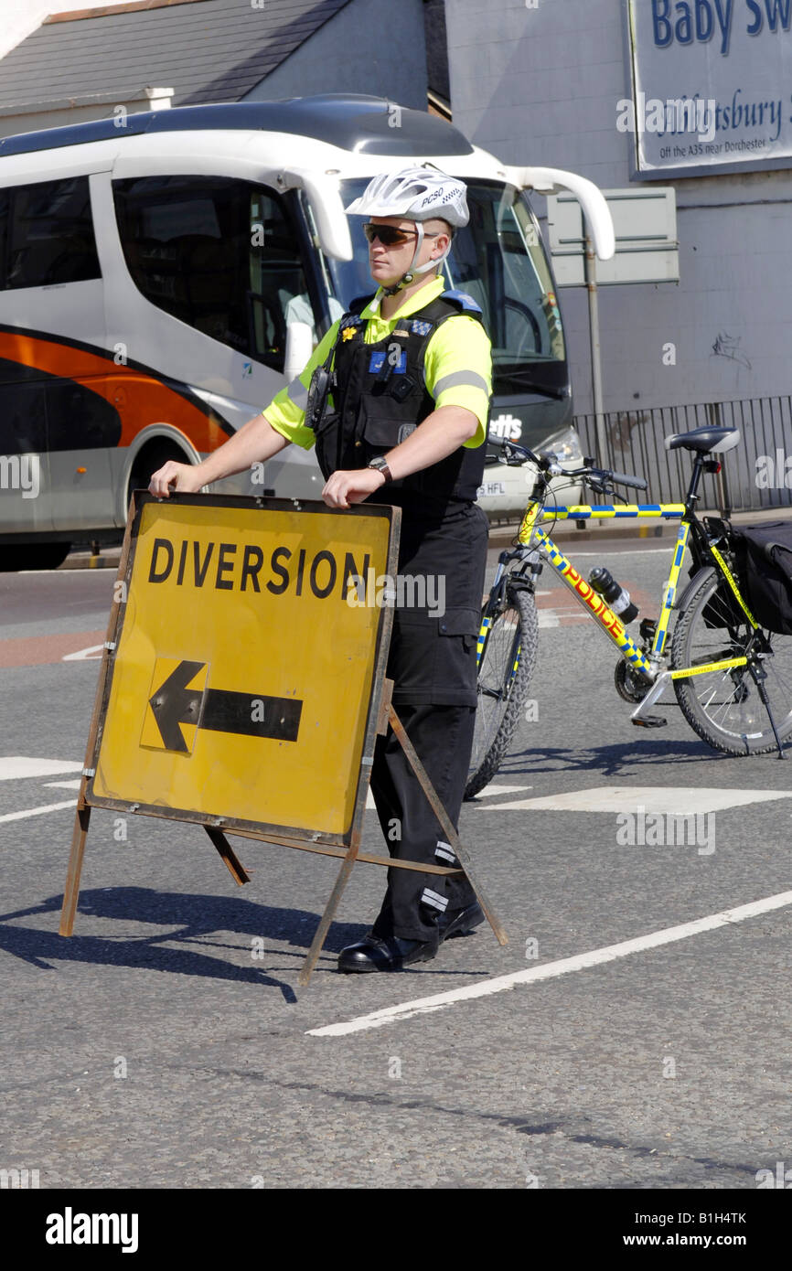 British Police officer setting road diversion signs in London due to a