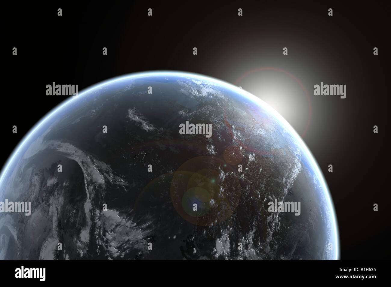 Sun emerging over planet earth Stock Photo