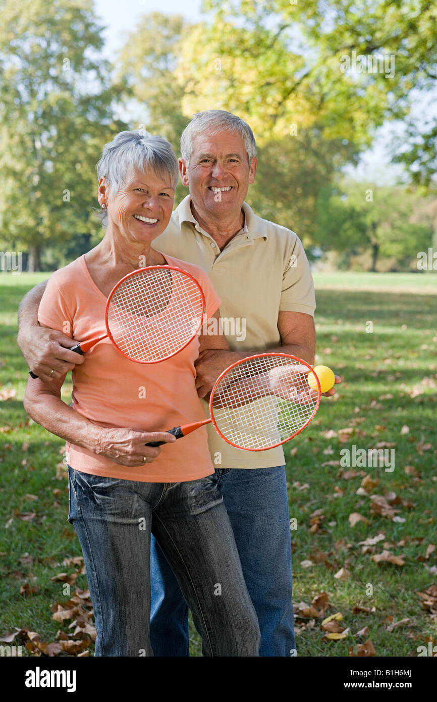 Senior couple playing badminton Stock Photo