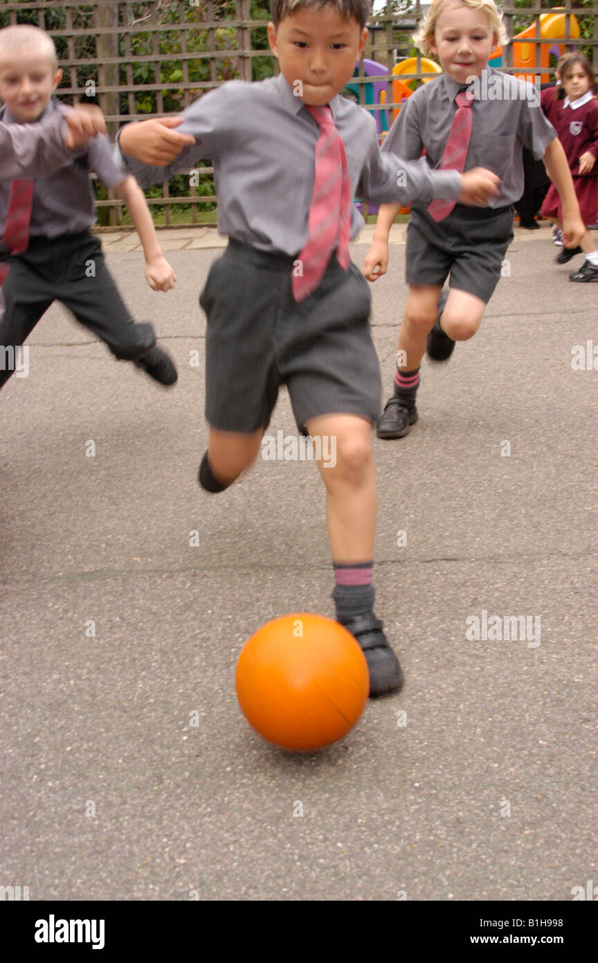 Boys kicking football school hires stock photography and images Alamy