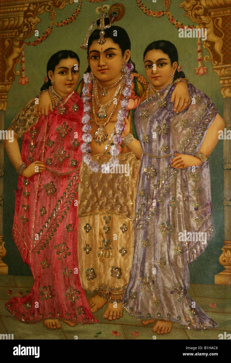 Antique painting with silk materials of Lord Krishna and his two wives Radha and Rukmani , India Stock Photo