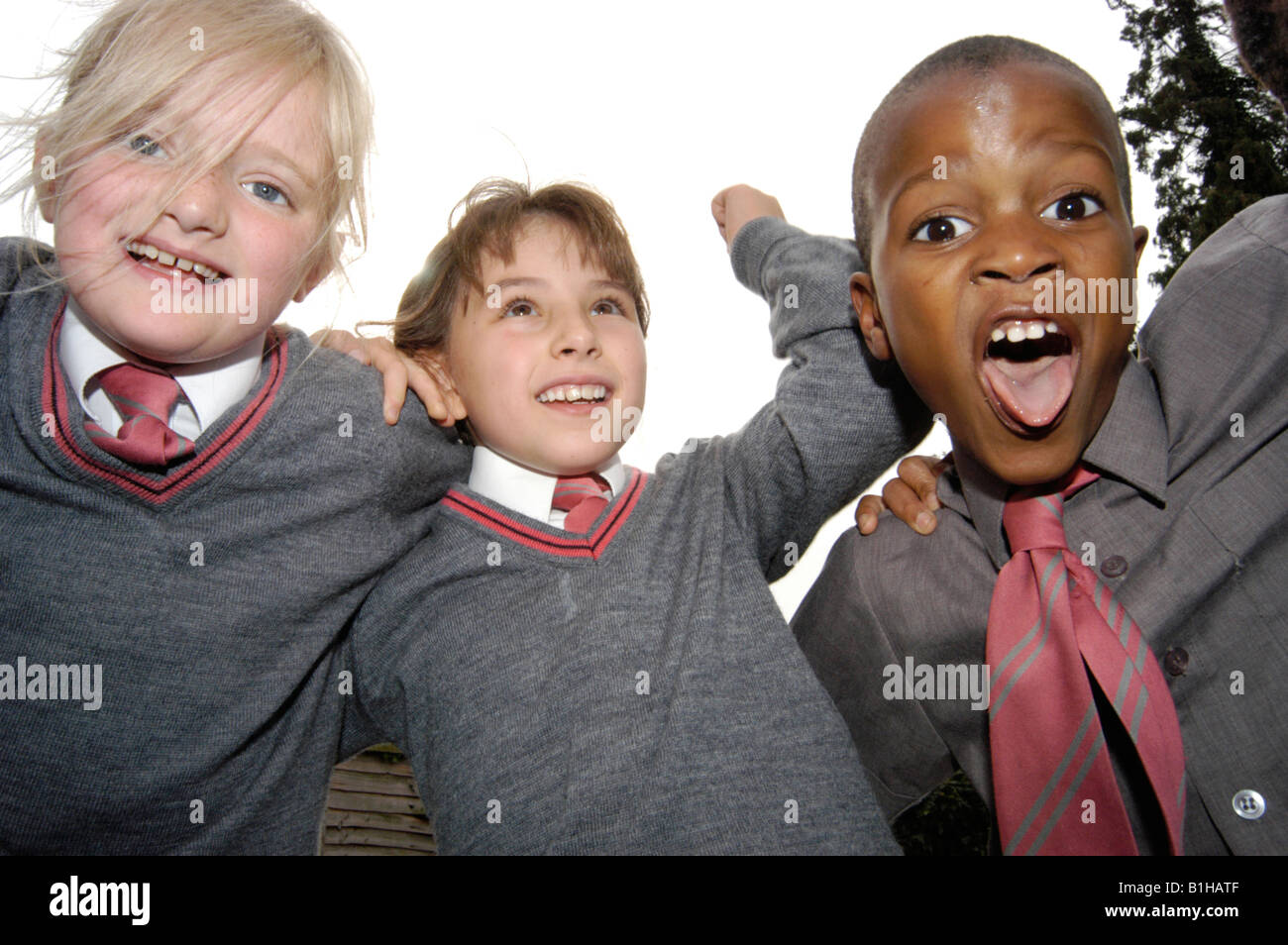 Children shouting and smiling in school in a group Stock Photo