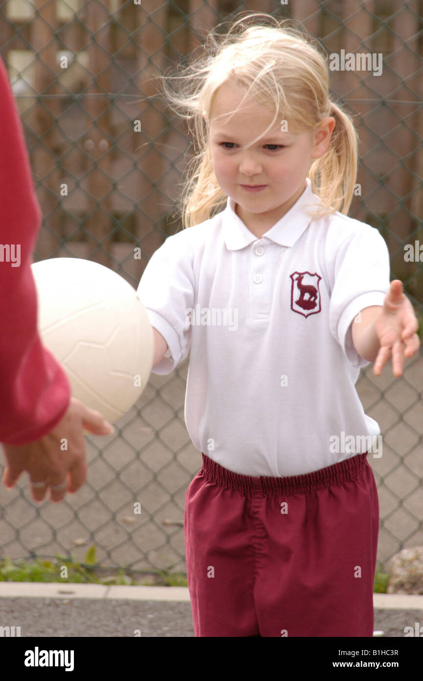 girl waiting to catch a ball in school sports Stock Photo
