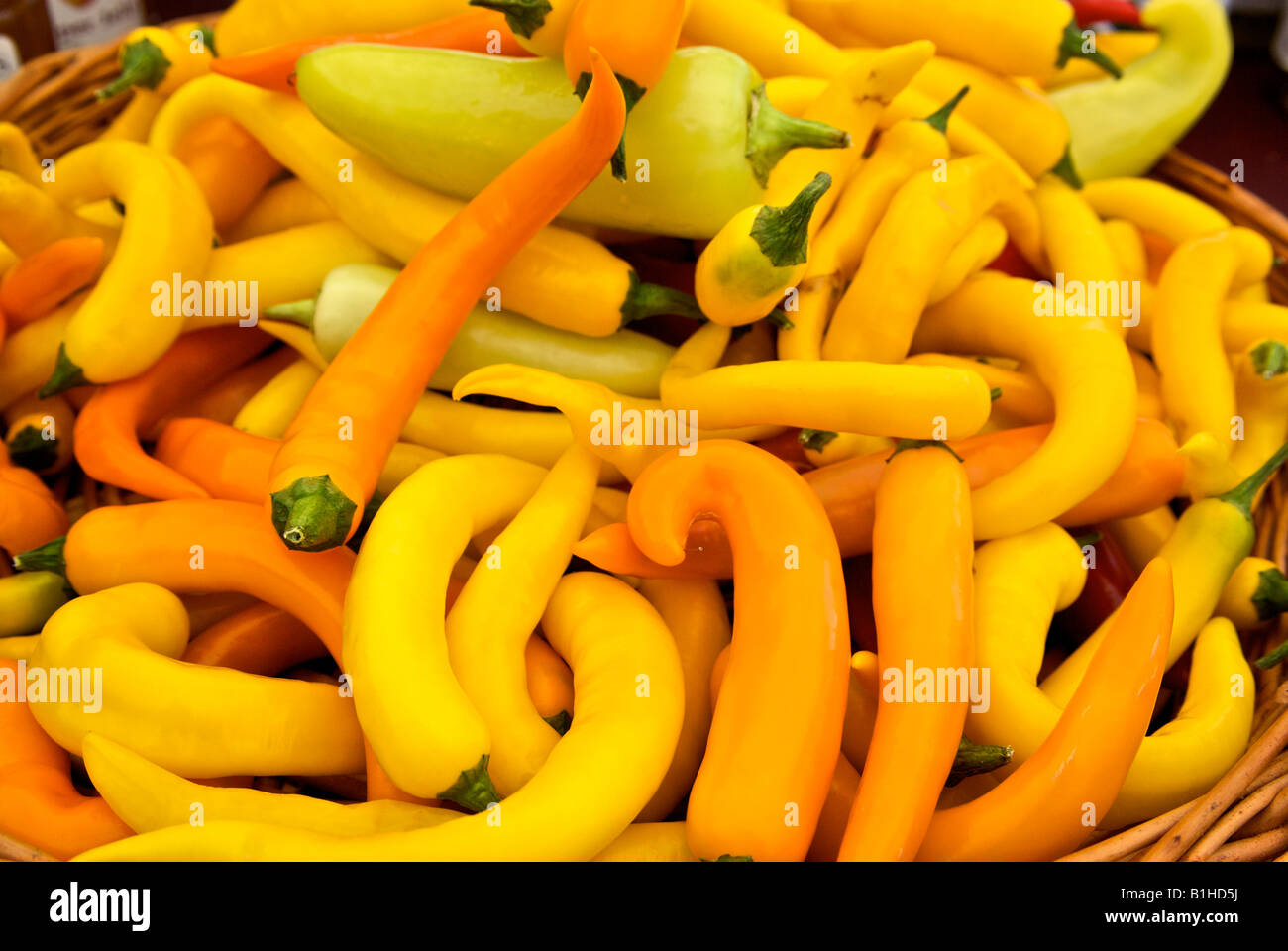 Basket of sweet yellow and orange peppers at farmer market Stock Photo ...