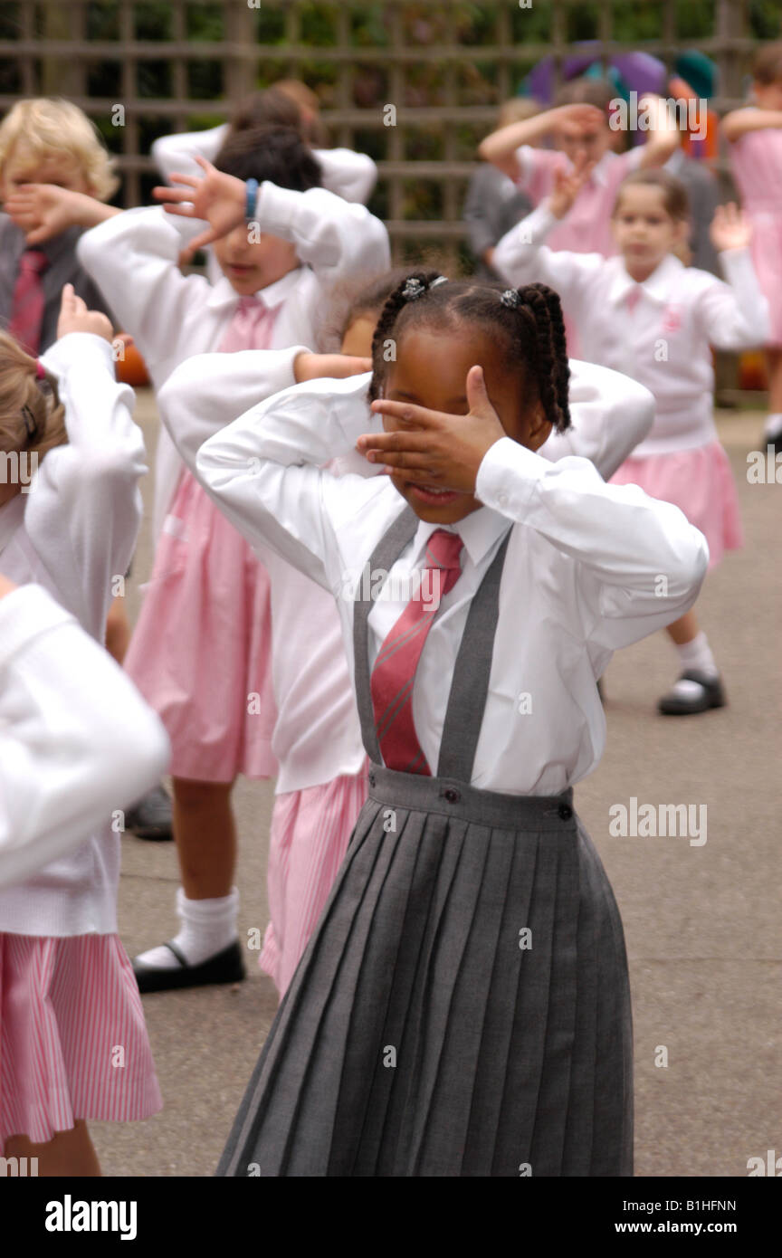 girls in playground covering their eyes Stock Photo