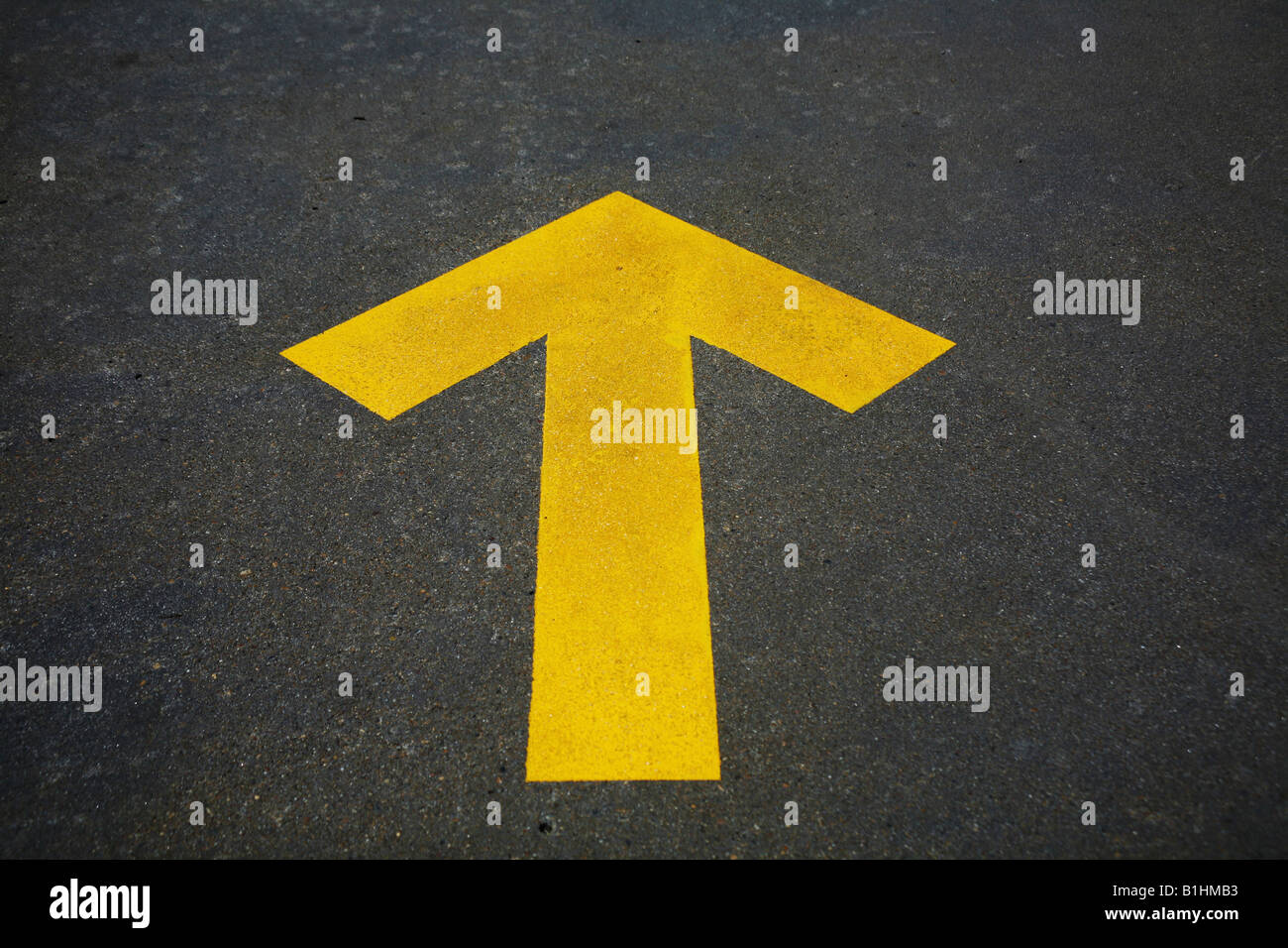 yellow arrow on road Stock Photo - Alamy