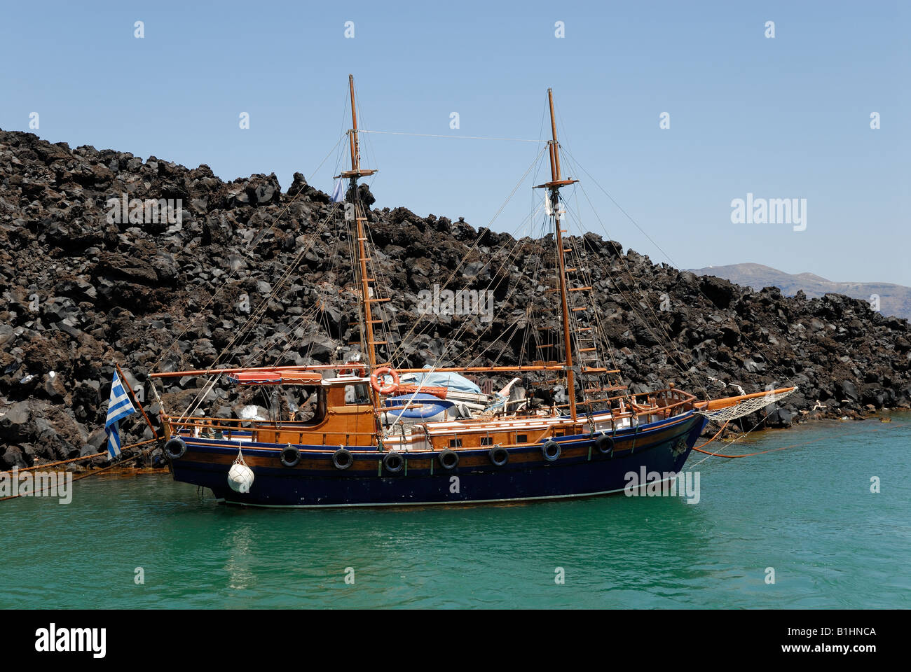 Traditional sailing boat anchored at the island Nea Kameni in Santorini, Greece Stock Photo