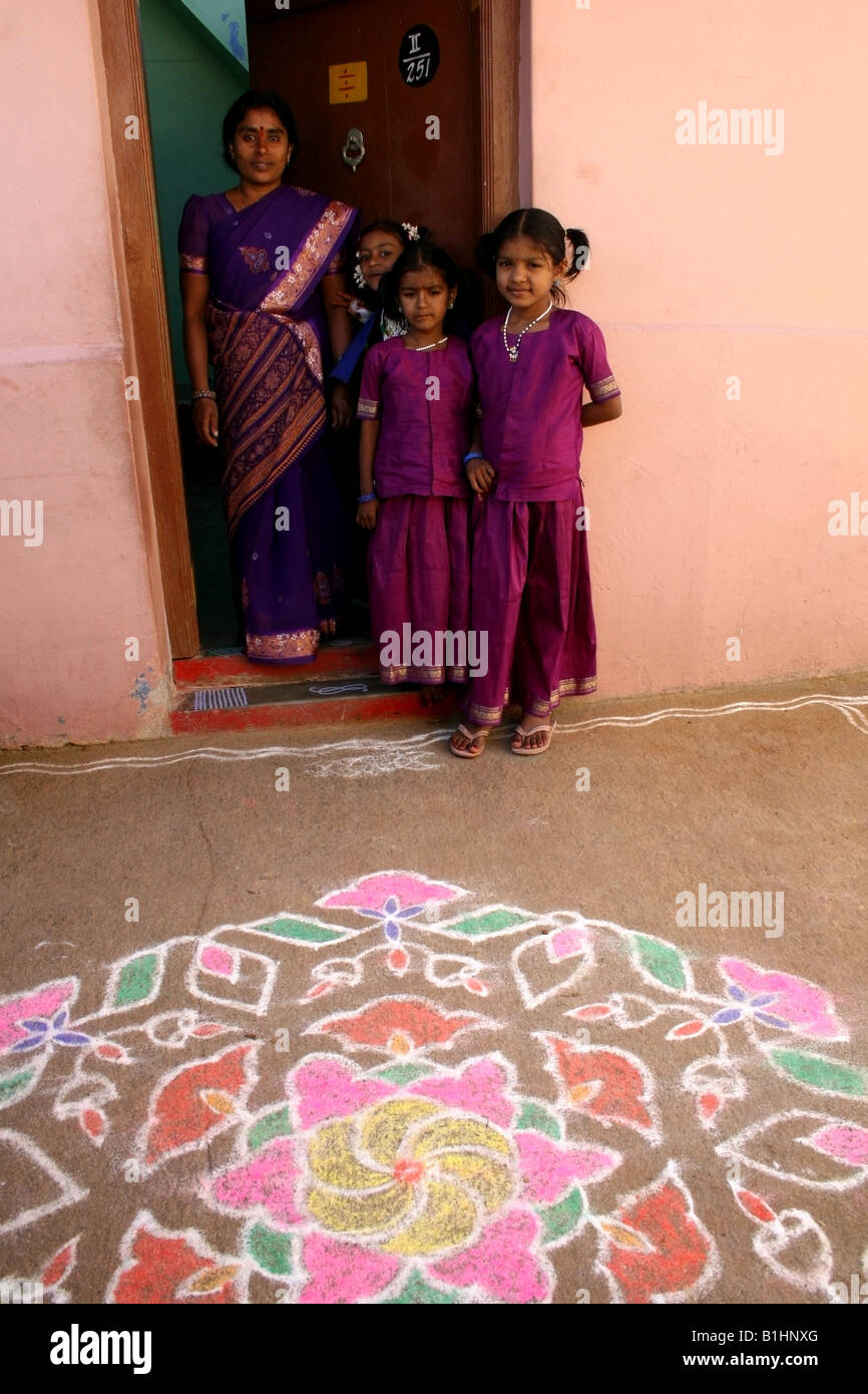 Family dressed in new clothes stand outside their house decorated with ...