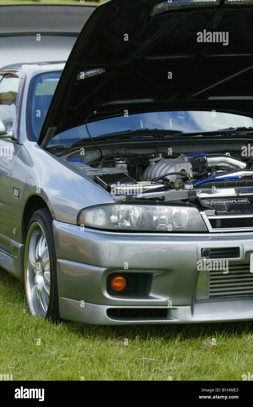 Nissan Skyline GT-R Metallic Grey Modified Spoiler Car Showfield Field Fast Car Bonnet Engine Stock Photo