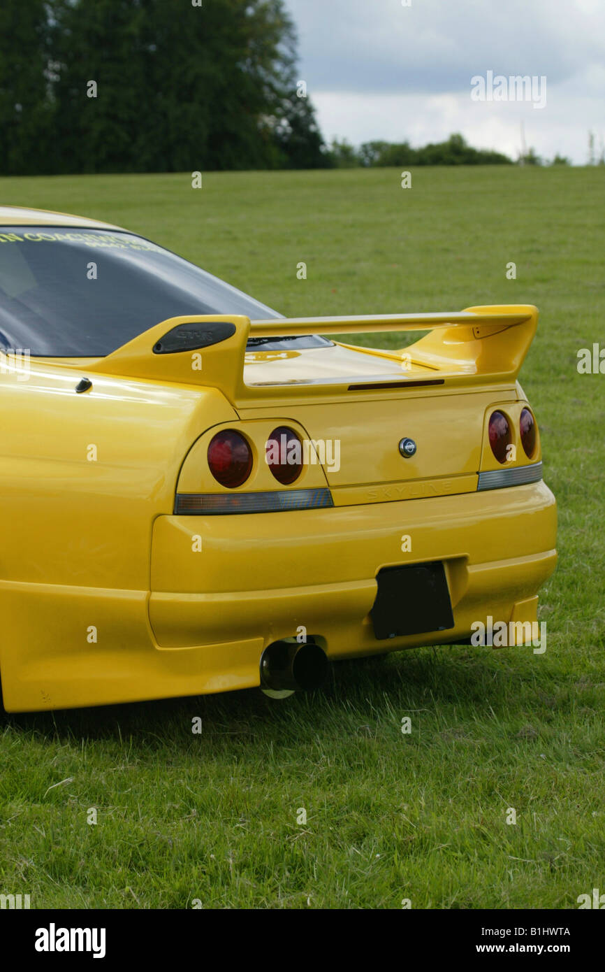 Nissan Skyline GT-R  Yellow Modified Spoiler Car Showfield Field Fast Car Stock Photo