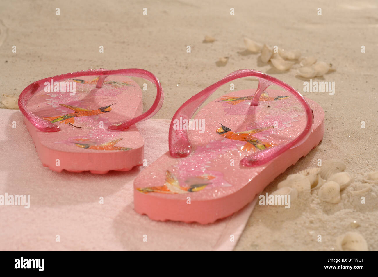 Pink flip flops in the sand Stock Photo - Alamy