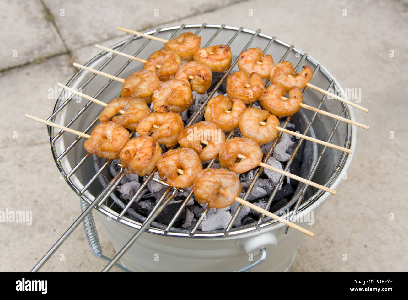 Barbecued king prawn kebabs, London, England. Stock Photo