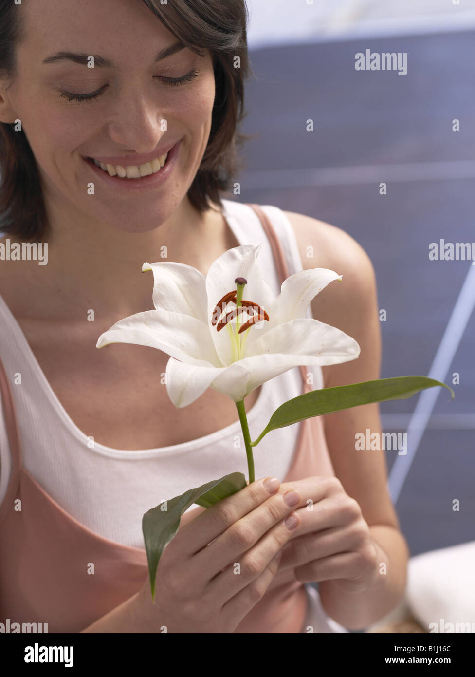 Woman with lily blossom Stock Photo - Alamy