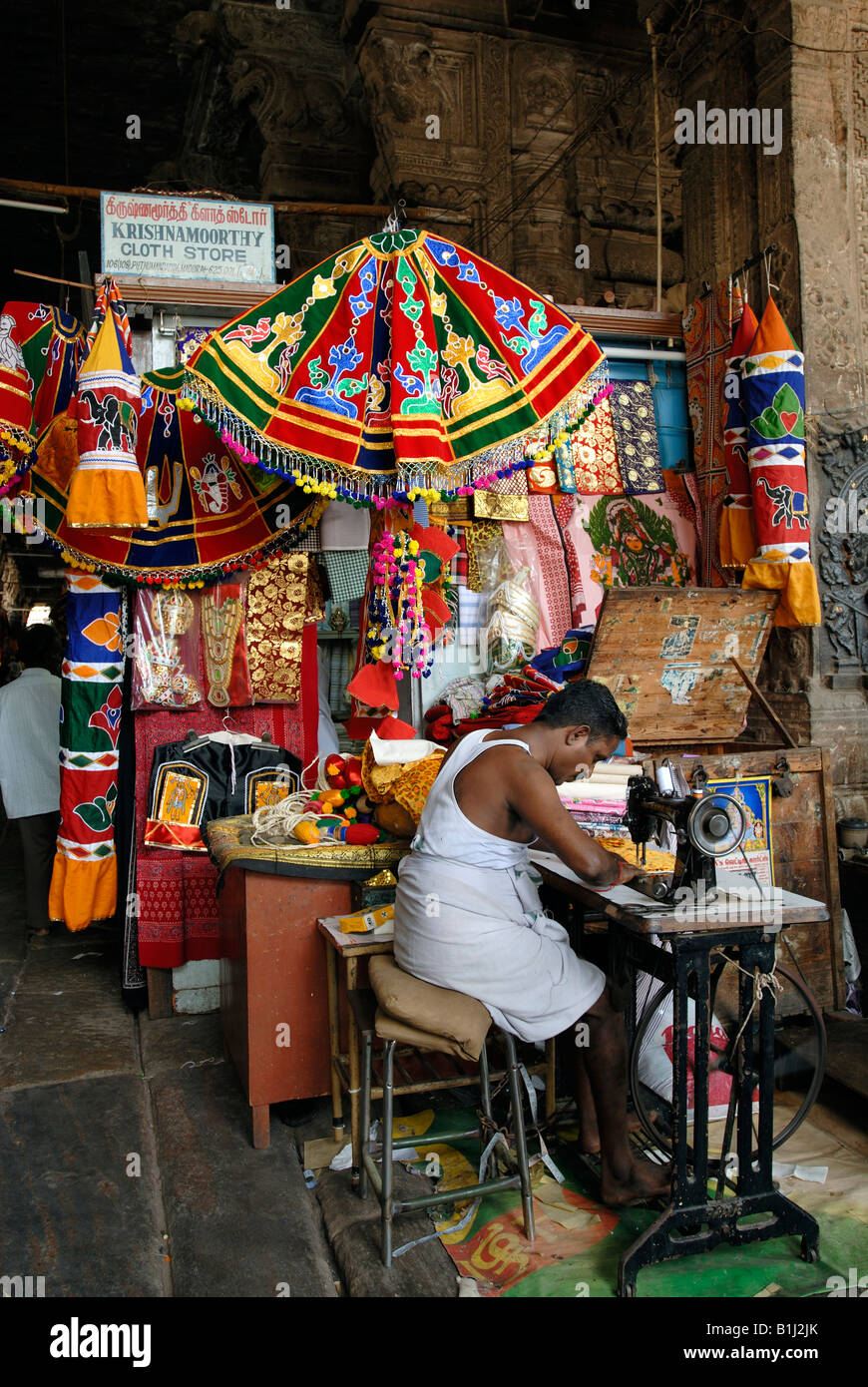 Tailor stitching umbrellas used for decorating the temple chariot, Sri