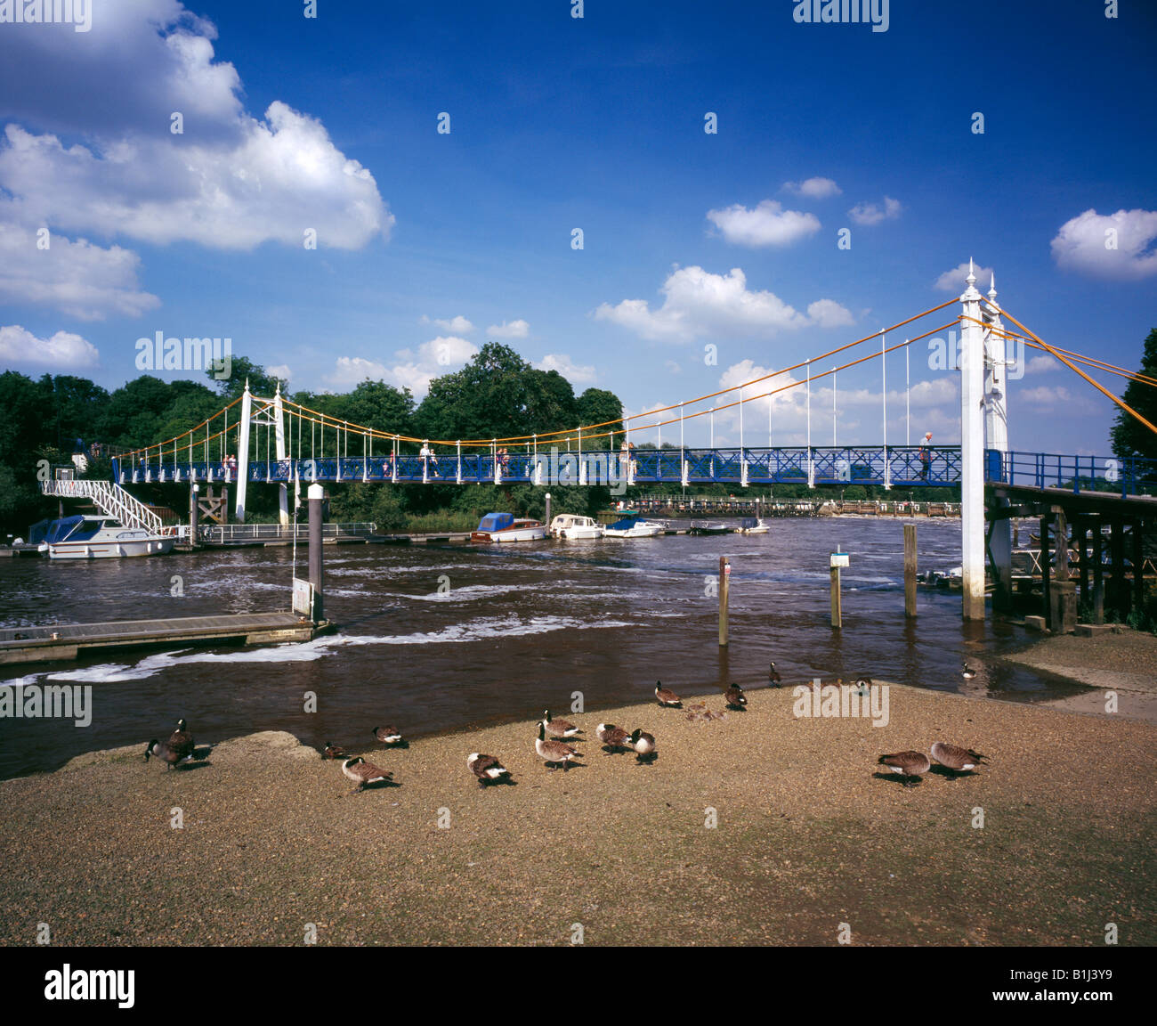 Teddington Lock suspension footbridge crossing the river Thames, London, Middlesex, England, UK. Stock Photo