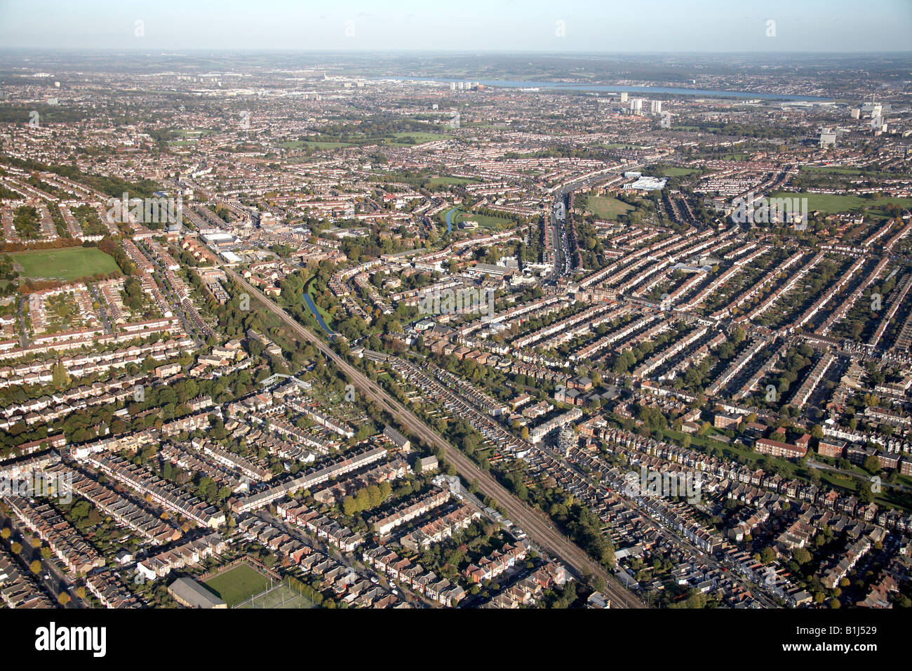 Aerial view north east of Broomfield Park Sports Ground railway line New River suburban houses Bowes Park London N13 England UK Stock Photo
