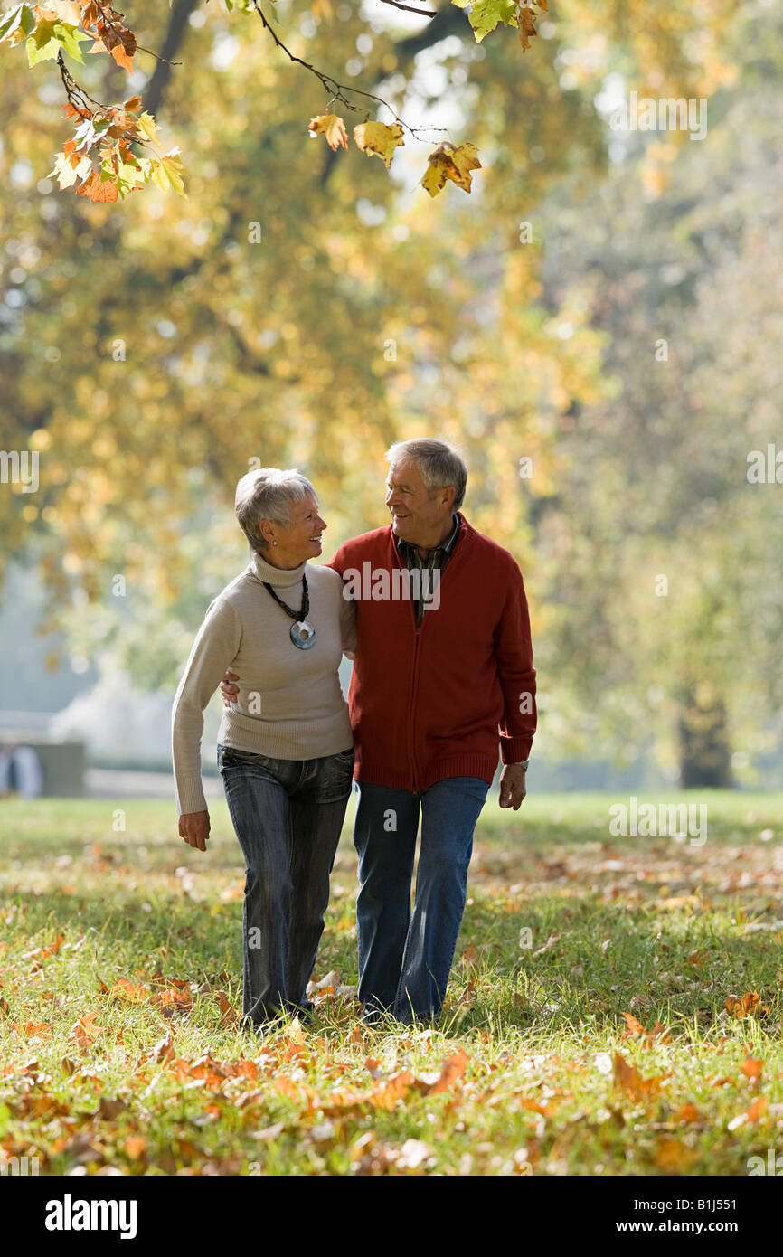Senior couple walking in a park Stock Photo - Alamy